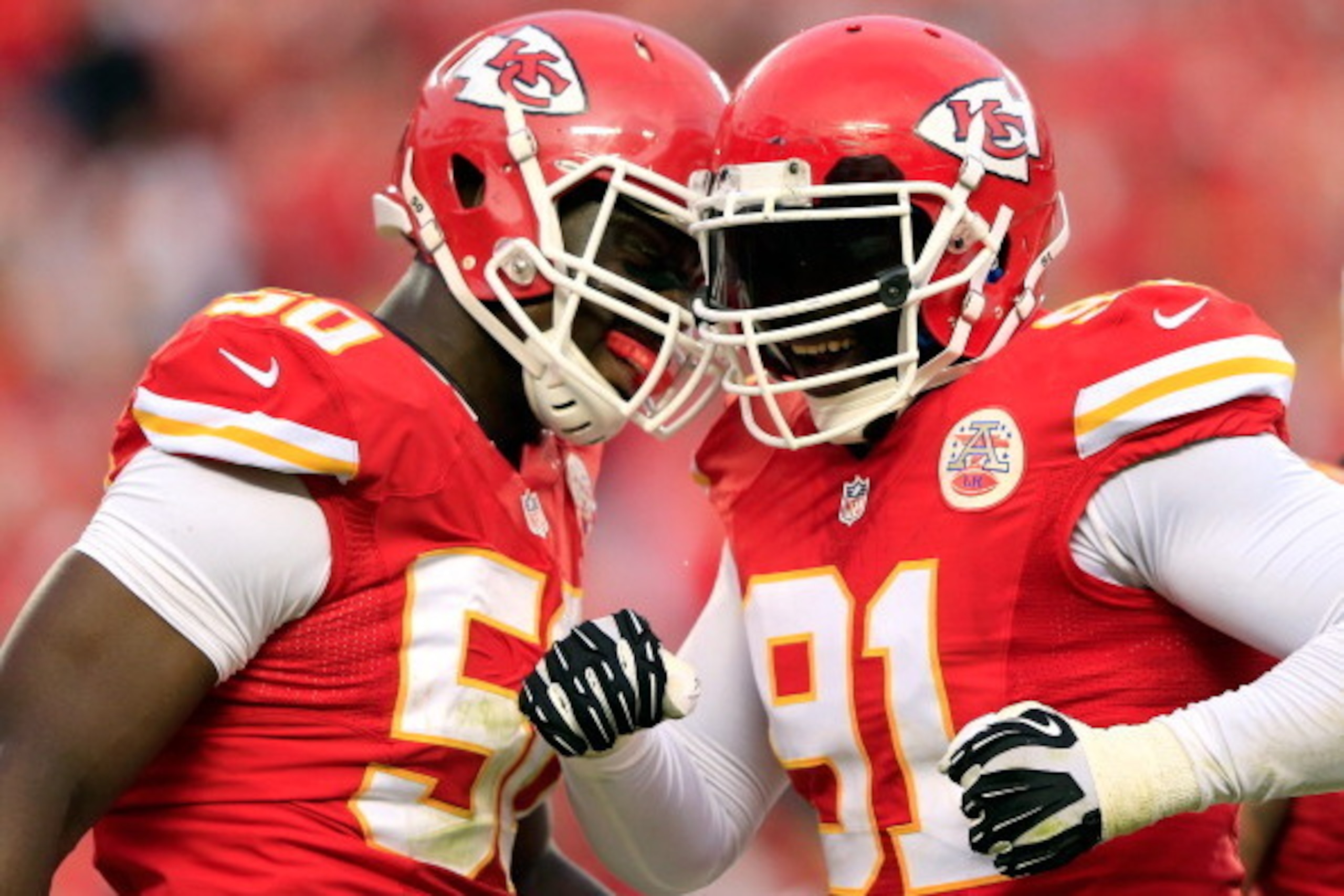 KANSAS CITY, MO - OCTOBER 20:  Outside linebacker Tamba Hali #91 of the Kansas City Chiefs is congratulated by outside linebacker Justin Houston #50 after sacking quarterback Case Keenum #7 of the Houston Texans late in the 2nd half of the game at Arrowhe