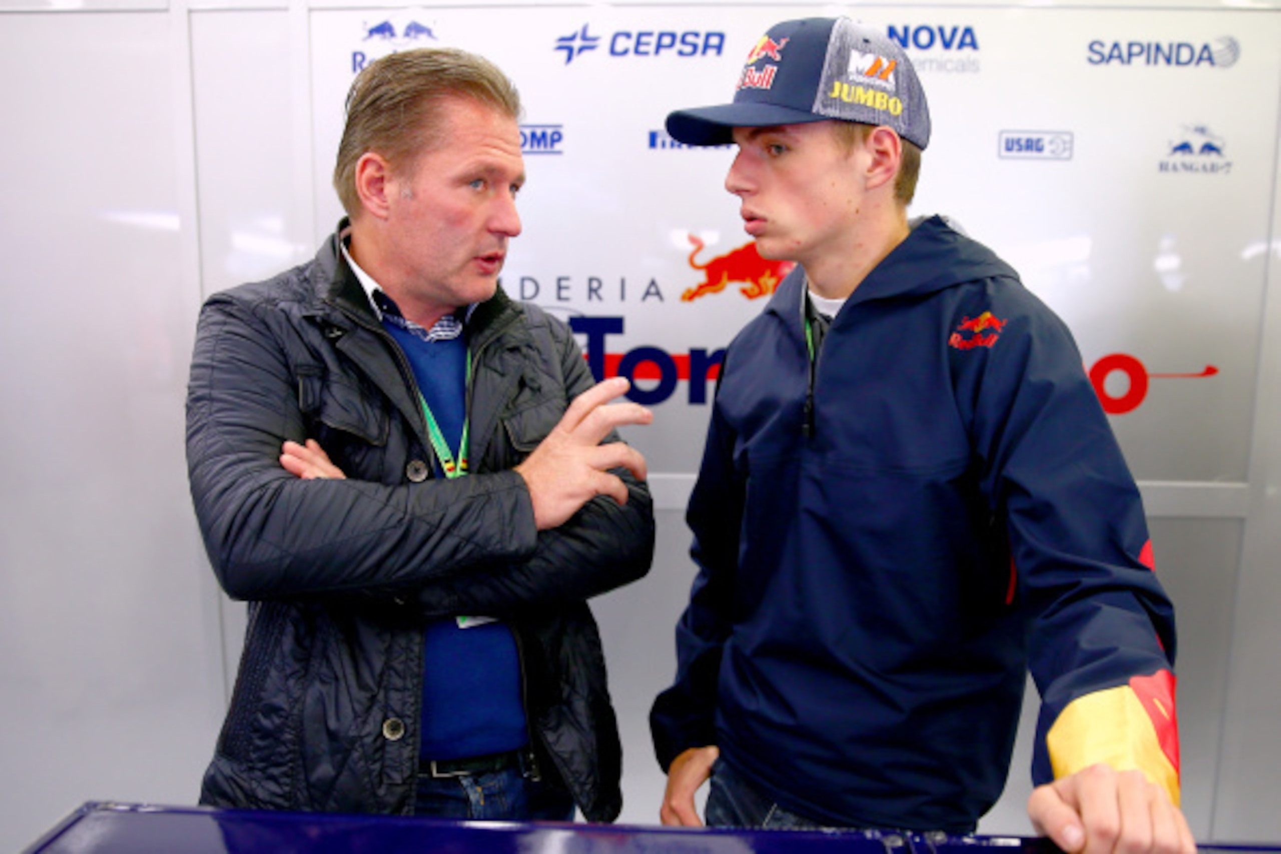SPA, BELGIUM - AUGUST 22:  Max Verstappen of Netherlands, who will drive for Scuderia Toro Rosso next season, speaks with his father Jos Verstappen in the Scuderia Toro Rosso garage during practice ahead of the Belgian Grand Prix at Circuit de Spa-Francor