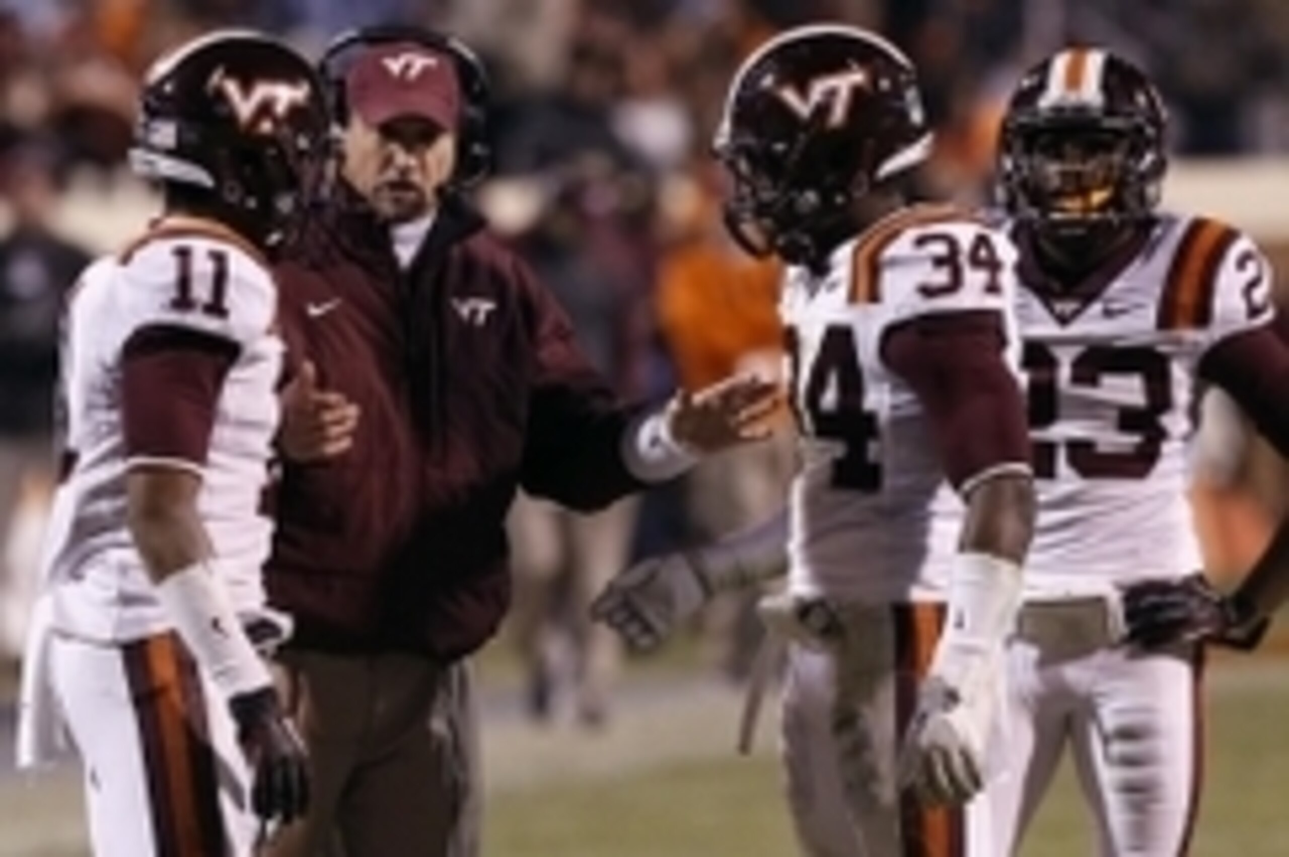 Nov 30, 2013; Charlottesville, VA, USA; Virginia Tech Hokies defensive coordinator Bud Foster (left) talks to his players against the Virginia Cavaliers in the third quarter at Scott Stadium. The Hokies won 16-6. Mandatory Credit: Geoff Burke-USA TODAY Sp