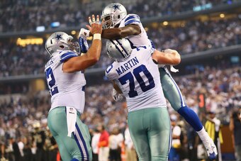 ARLINGTON, TX - SEPTEMBER 28:  Dez Bryant #88 of the Dallas Cowboys celebrates a touchdown with  Zack Martin #70 and Travis Frederick #72 against the New Orleans Saints at AT&T Stadium on September 28, 2014 in Arlington, Texas.  (Photo by Ronald Martinez/