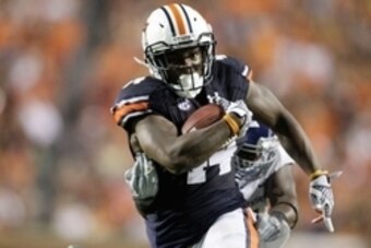 Sep 6, 2014; Auburn, AL, USA;  Auburn Tigers running back Cameron Artis-Payne (44) avoids the tackle of San Jose State Spartans defensive end Adrian Blake (91) during the first half at Jordan Hare Stadium.  Mandatory Credit: John Reed-USA TODAY Sports