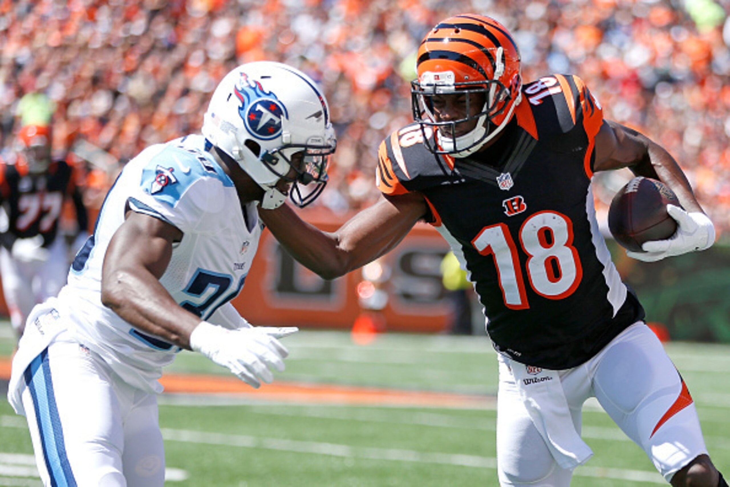 CINCINNATI, OH - SEPTEMBER 21: A.J. Green #18 of the Cincinnati Bengals stiff arms Jason McCourty #30 of the Tennessee Titans during the first quarter at Paul Brown Stadium on September 21, 2014 in Cincinnati, Ohio. (Photo by Joe Robbins/Getty Images) CINCINNATI, OH - SEPTEMBER 21: A.J. Green #18 of the Cincinnati Bengals stiff arms Jason McCourty #30 of the Tennessee Titans during the first quarter at Paul Brown Stadium on September 21, 2014 in Cincinnati, Ohio. (Photo by Joe Robbins/Getty Images)