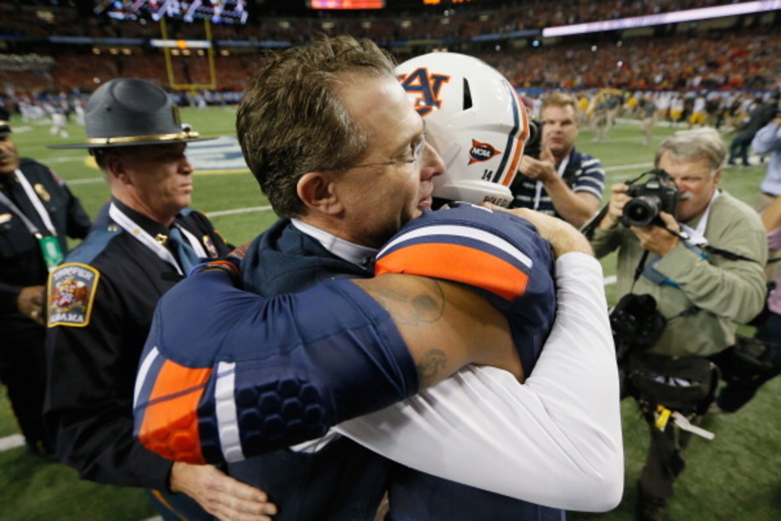 ATLANTA, GA - DECEMBER 07: Head coach Gus Malzahn of the Auburn Tigers hugs quarterback Nick Marshall #14 of the Auburn Tigers in celebration of their 59-42 win over the Missouri Tigers 59-42 to win the SEC Championship Game at Georgia Dome on December 7 ATLANTA, GA - DECEMBER 07: Head coach Gus Malzahn of the Auburn Tigers hugs quarterback Nick Marshall #14 of the Auburn Tigers in celebration of their 59-42 win over the Missouri Tigers 59-42 to win the SEC Championship Game at Georgia Dome on December 7