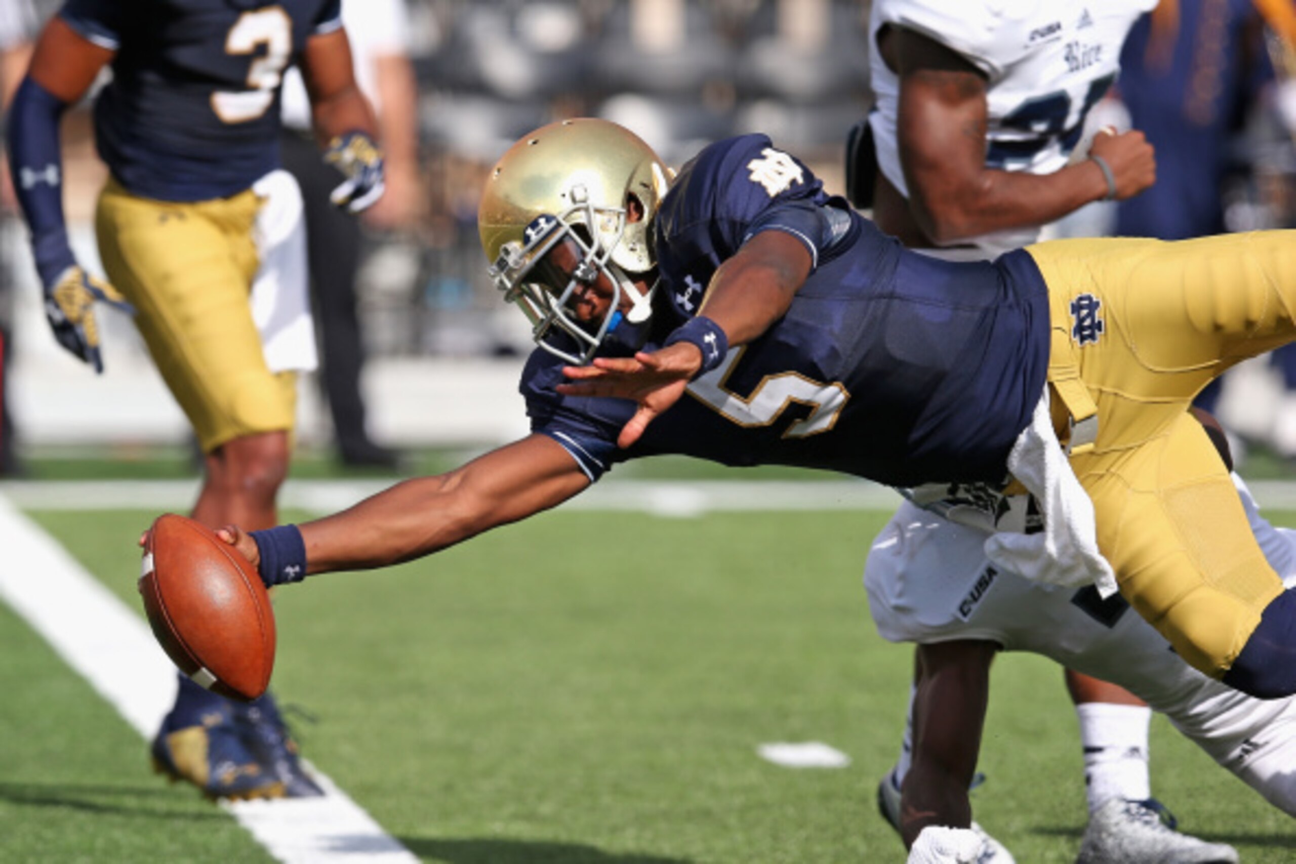 SOUTH BEND, IN - AUGUST 30:  Everett Golson #5 of the Norte Dame Fighting Irish dives into the end zone for a touchdown against the Rice Owls at Notre Dame Stadium on August 30, 2014 in South Bend, Indiana. Notre Dame defeated Rice 48-17. (Photo by Jonath