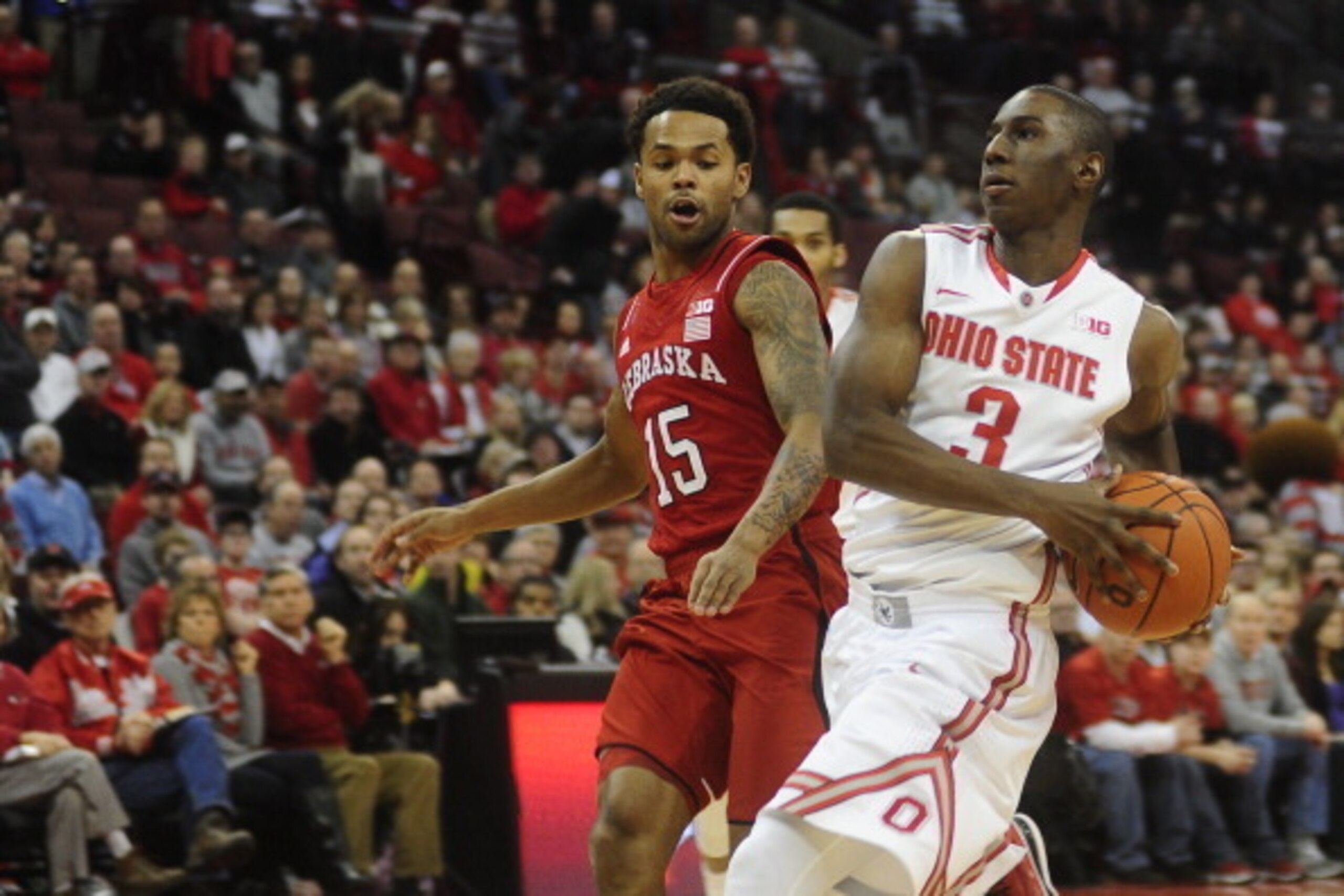 COLUMBUS, OH - JANUARY 4:  Shannon Scott #3 of the Ohio State Buckeyes goes to the basket against Ray Gallegos #15 of the Nebraska Cornhuskers on January 4, 20114 at Value City Arena in Columbus, Ohio.   (Photo by Ryan Young/Getty Images)