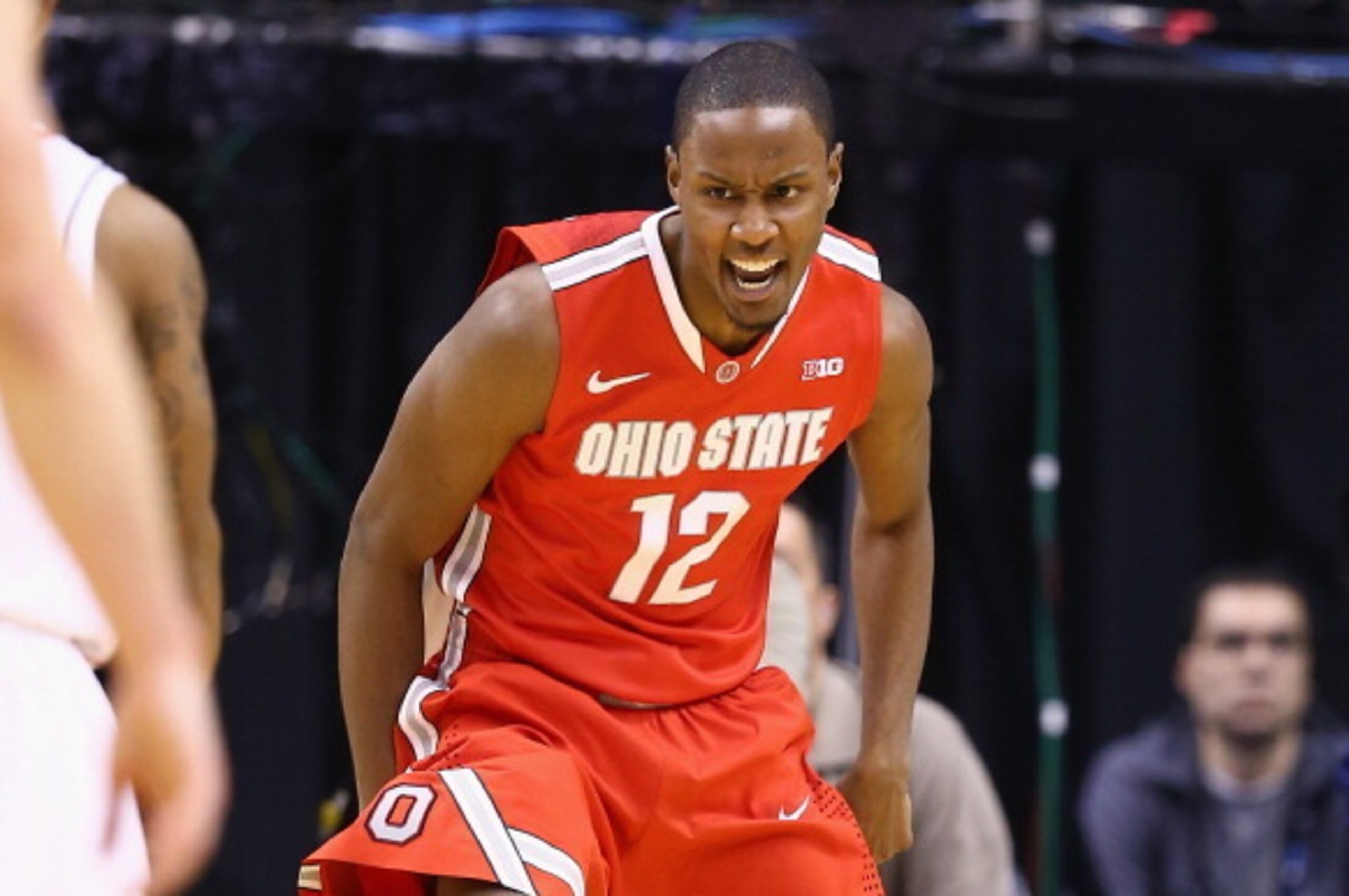 INDIANAPOLIS, IN - MARCH 14:  Sam Thompson #12 of the Ohio State Buckeyes celebrates during the 71-67 win over the Nebraska Cornhuskers during the Quarterfinals of the Big Ten Basketball Tournament at Bankers Life Fieldhouse on March 14, 2014 in Indianapo