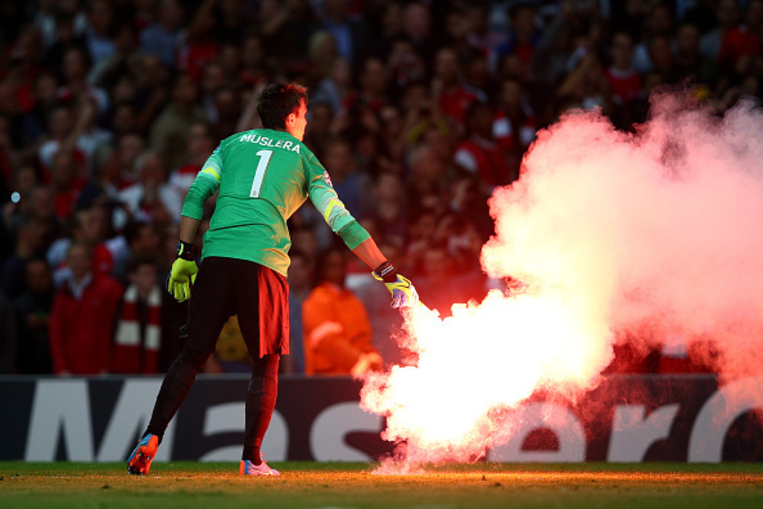 LONDON, ENGLAND - OCTOBER 01:  Fernando Muslera of Galatasaray AS carries a flare off the pitch during the UEFA Champions League group D match between Arsenal FC and Galatasaray AS at Emirates Stadium on October 1, 2014 in London, United Kingdom.  (Photo 
