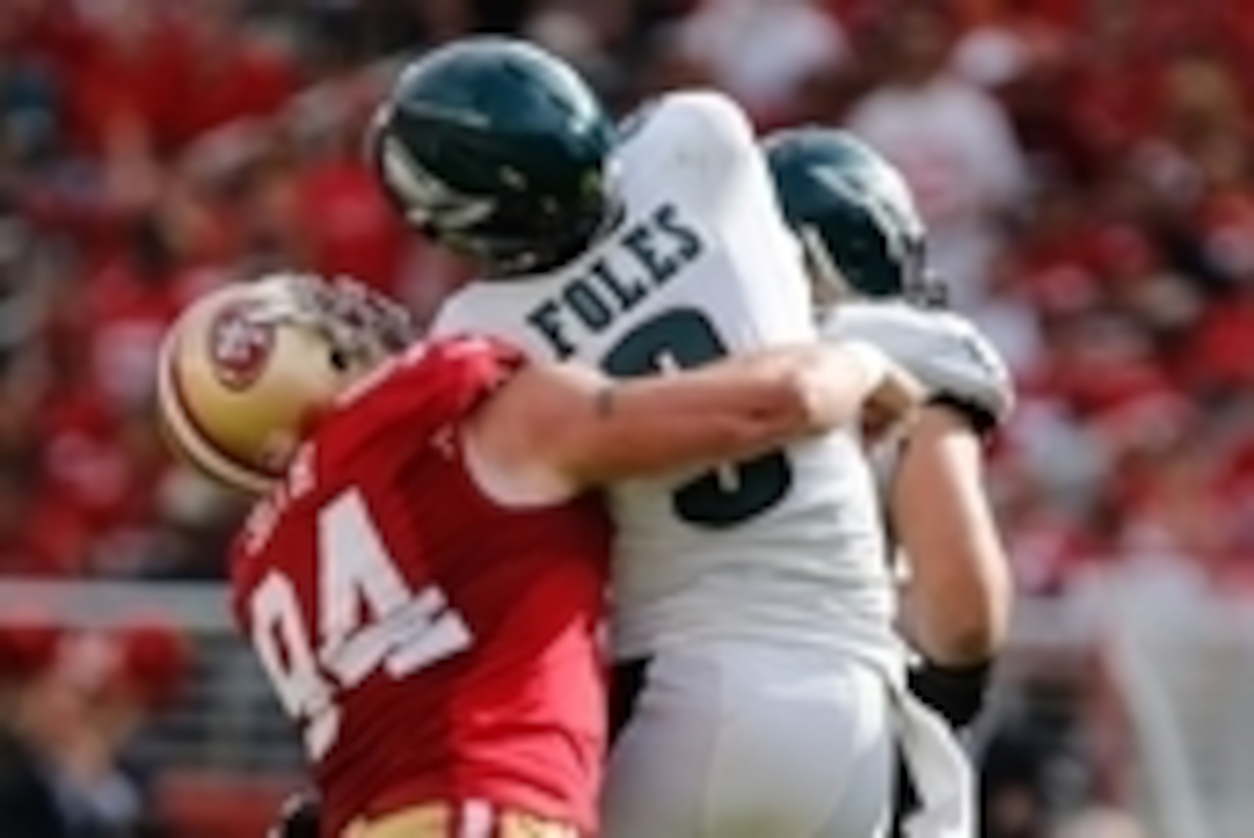 Sep 28, 2014; Santa Clara, CA, USA; San Francisco 49ers defensive end Justin Smith (94) puts pressure on Philadelphia Eagles quarterback Nick Foles (9) resulting in an interception during the third quarter at Levi's Stadium. The San Francisco 49ers defeat