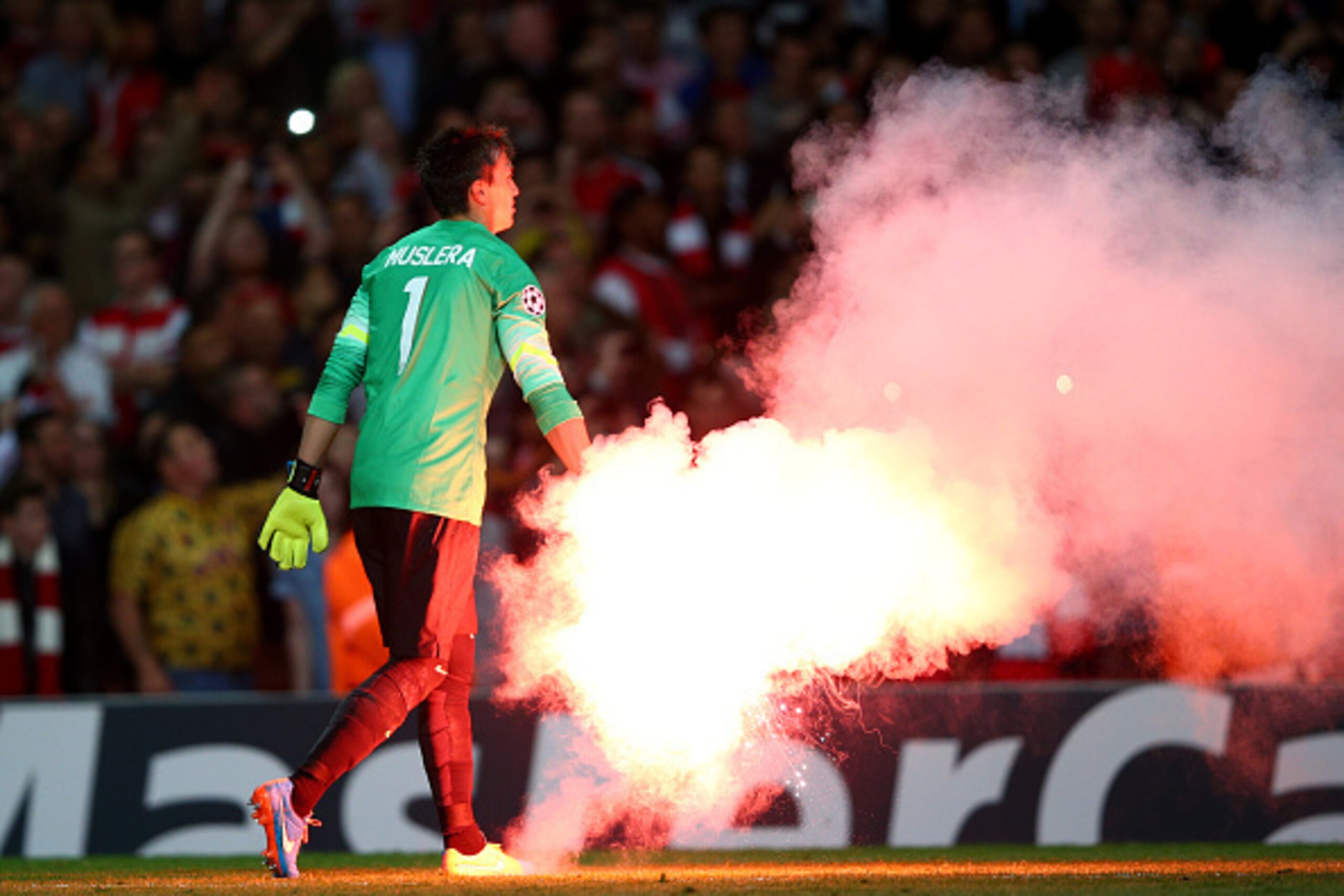 LONDON, ENGLAND - OCTOBER 01:  Fernando Muslera of Galatasaray AS carries a flare off the pitch during the UEFA Champions League group D match between Arsenal FC and Galatasaray AS at Emirates Stadium on October 1, 2014 in London, United Kingdom.  (Photo 