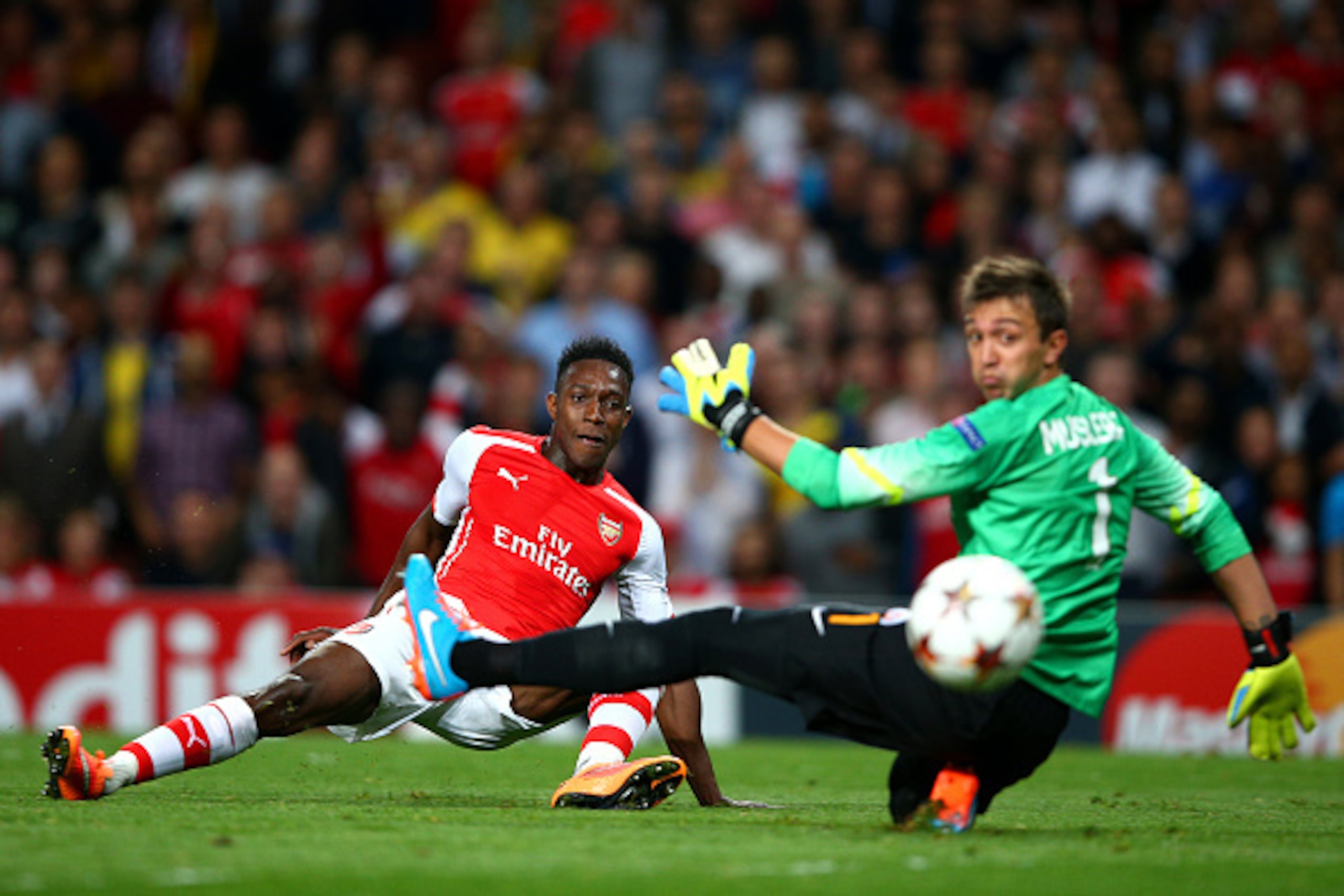 LONDON, ENGLAND - OCTOBER 01:  Danny Welbeck of Arsenal scores his team's second goal past Fernando Muslera of Galatasaray AS during the UEFA Champions League group D match between Arsenal FC and Galatasaray AS at Emirates Stadium on October 1, 2014 in Lo