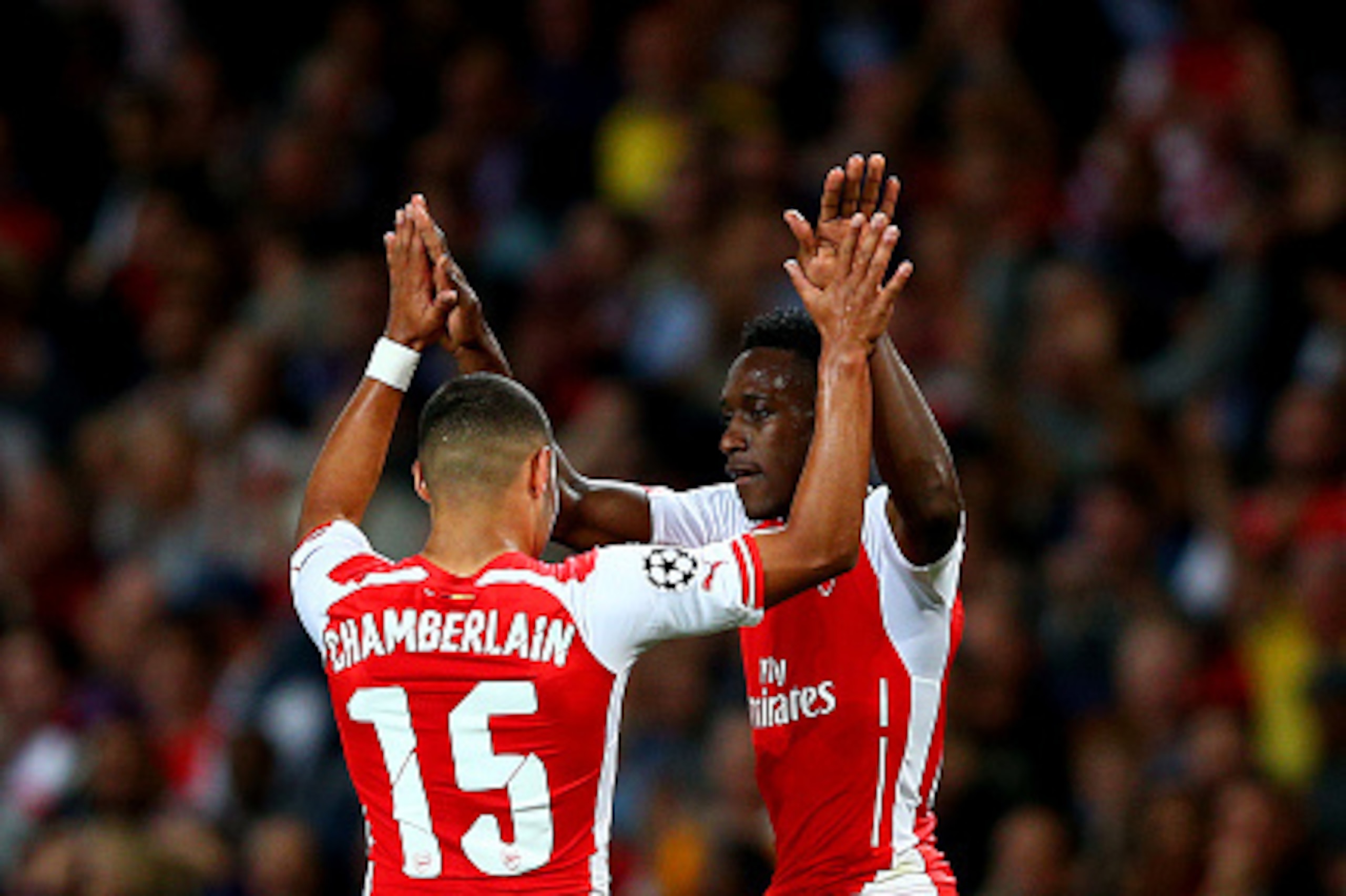 LONDON, ENGLAND - OCTOBER 01:  Danny Welbeck of Arsenal celebrates with team-mate Alex Oxlade-Chamberlain after scoring his team's second goal during the UEFA Champions League group D match between Arsenal FC and Galatasaray AS at Emirates Stadium on Octo