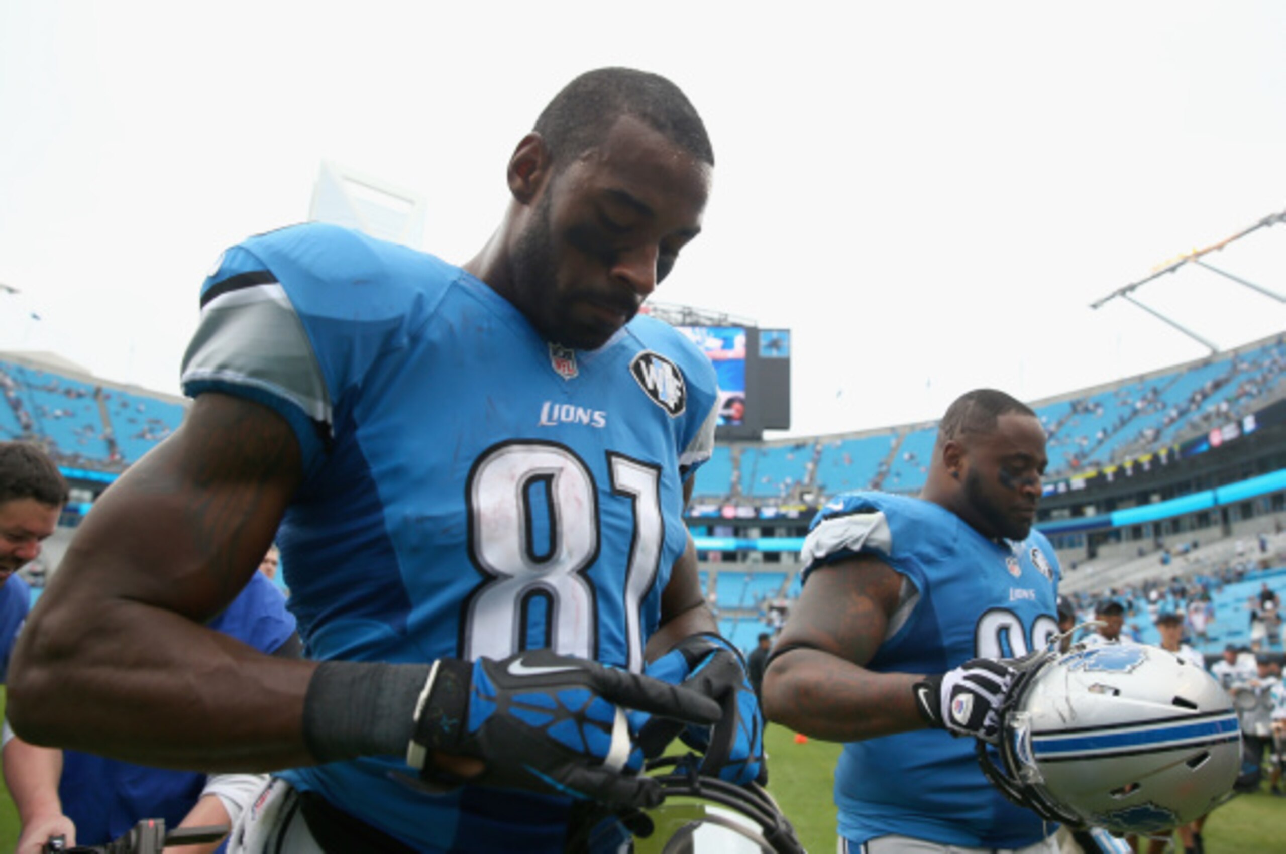 CHARLOTTE, NC - SEPTEMBER 14:   Calvin Johnson #81 and teammate  C.J. Mosley #99 of the Detroit Lions walk off the field after losing to the Carolina Panthers 24-7 during the game at Bank of America Stadium on September 14, 2014 in Charlotte, North Caroli