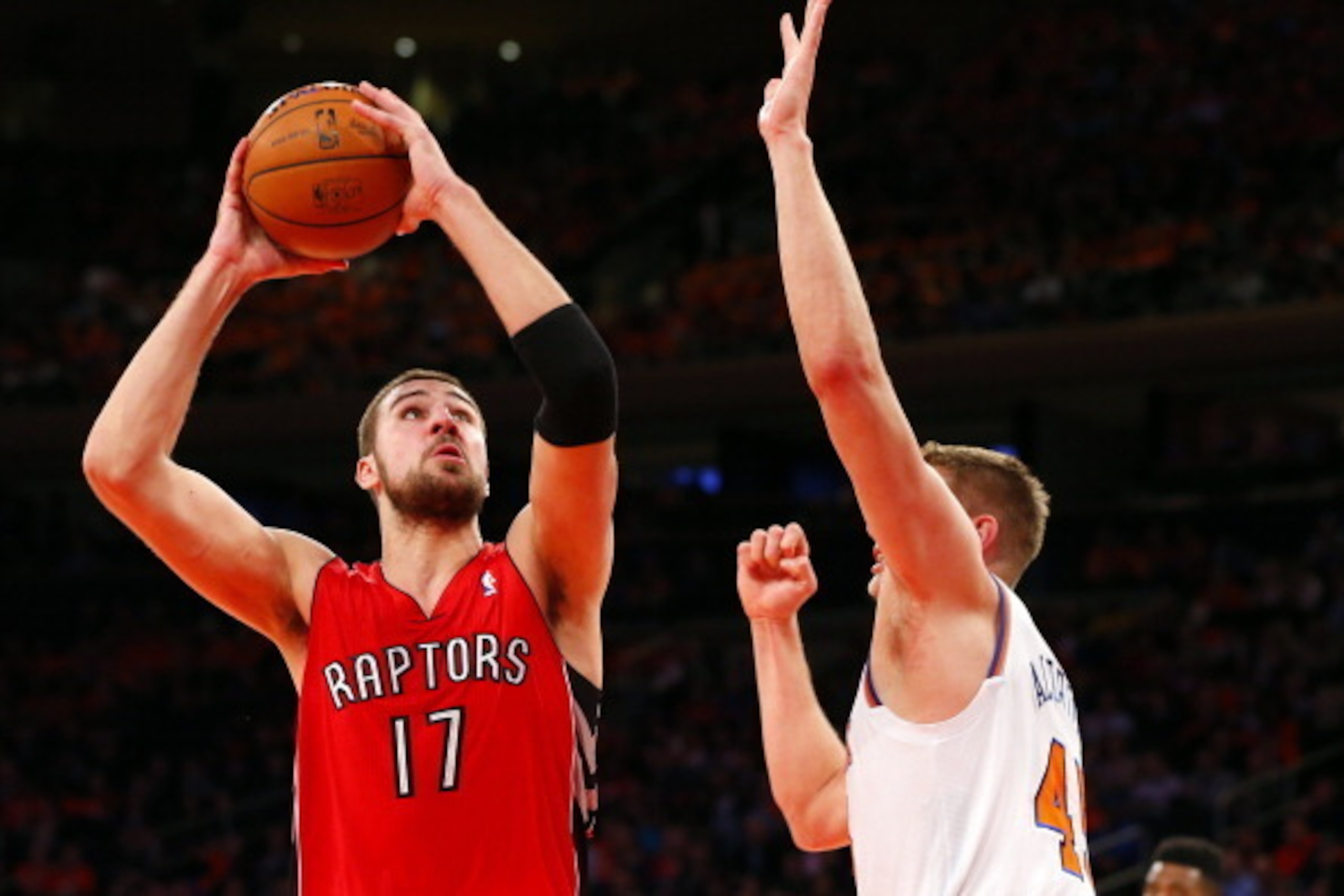 NEW YORK, NY - APRIL 16: Jonas Valanciunas #17 of the Toronto Raptors takes a shot as Cole Aldrich #45 of the New York Knicks defends in the first half during an NBA basketball game at Madison Square Garden on April. 16, 2014 in New York City. The Knicks 