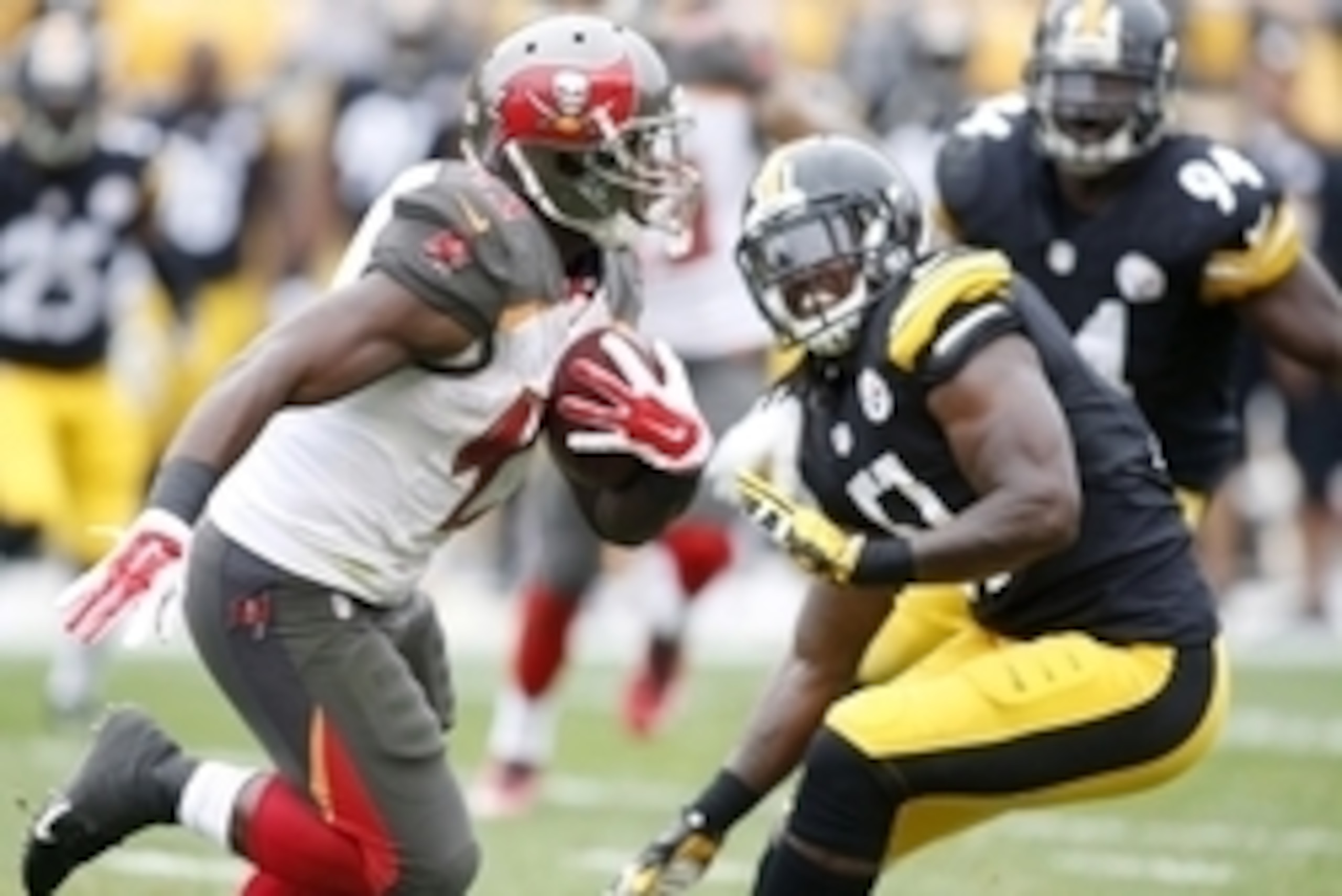 Sep 28, 2014; Pittsburgh, PA, USA; Tampa Bay Buccaneers running back Bobby Rainey (43) carries the ball past Pittsburgh Steelers linebacker Sean Spence (51) during the second quarter at Heinz Field. The Buccaneers won 27-24. Mandatory Credit: Charles LeCl