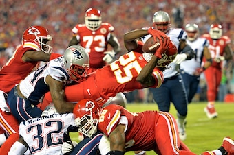 KANSAS CITY, MO - SEPTEMBER 29:   Jamaal Charles #25 of the Kansas City Chiefs dives in for a touchdown against the New England Patriots during the second quarter at Arrowhead Stadium on September 29, 2014 in Kansas City, Missouri.  (Photo by Peter Aiken/
