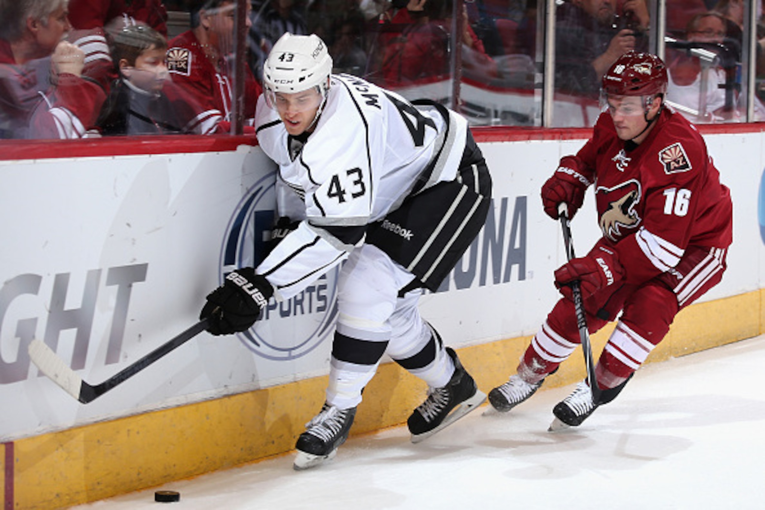 GLENDALE, AZ - SEPTEMBER 22:  Brayden McNabb #43 of the Los Angeles Kings attempts to control the puck ahead of Max Domi #16 of the Arizona Coyotes  during the first period of the preseason NHL game at Gila River Arena on September 22, 2014 in Glendale, A