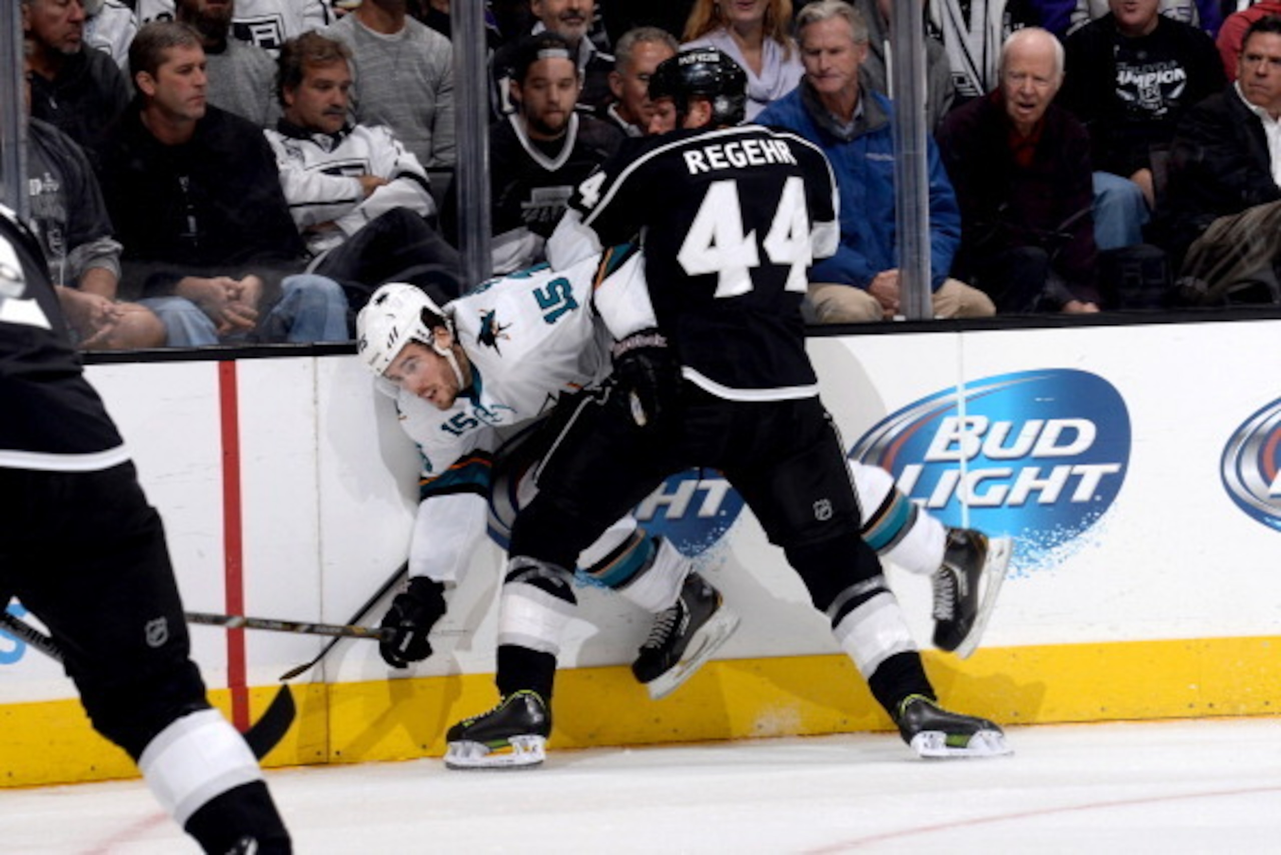 LOS ANGELES, CA - OCTOBER 30:  Robyn Regehr #44 of the Los Angeles Kings throws the check against James Sheppard #15 of the San Jose Sharks at Staples Center on October 30, 2013 in Los Angeles, California. (Photo by Noah Graham/NHLI via Getty Images)