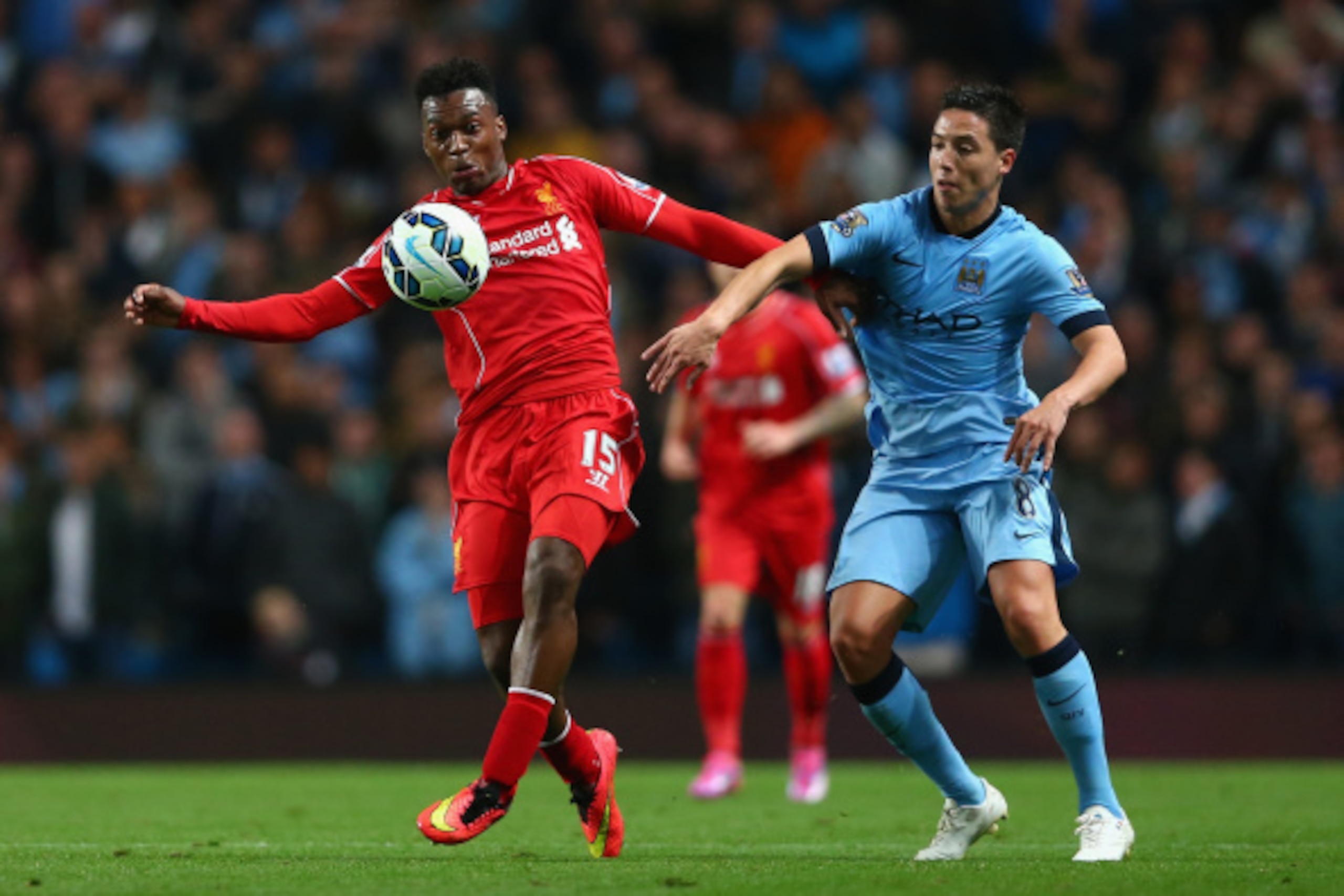 MANCHESTER, ENGLAND - AUGUST 25:  Daniel Sturridge of Liverpool holds off Samir Nasri of Manchester City during the Barclays Premier League match between Manchester City and Liverpool at the Etihad Stadium on August 25, 2014 in Manchester, England.  (Phot