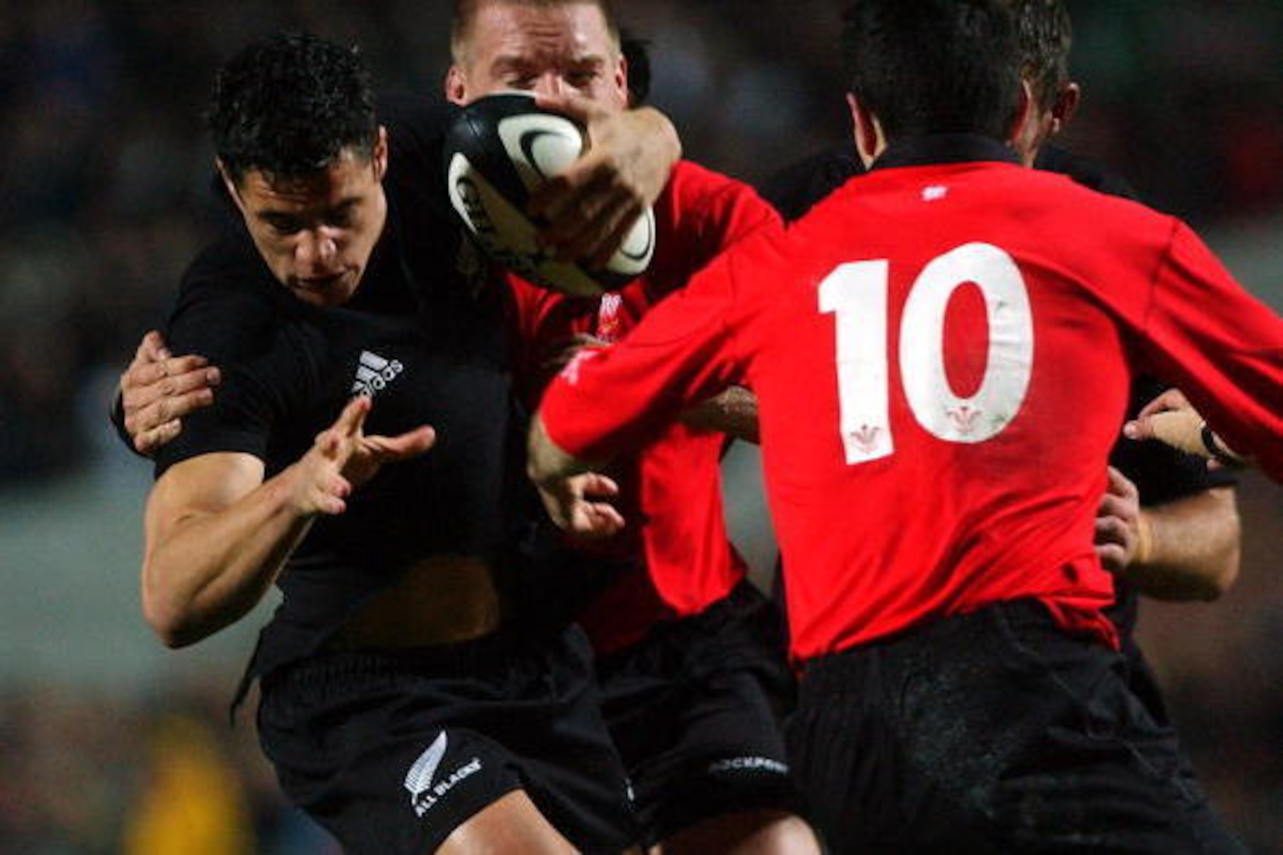 HAMILTON, NEW ZEALAND - JUNE 23:  New cap Dan Carter tries to find a way through Stephen Jones (10) during the New Zealand V Wales rugby union match in Hamilton, New Zealand, Saturday. The All Blacks won the match553.Fotopress/Ross Land..  (Photo by Ross 