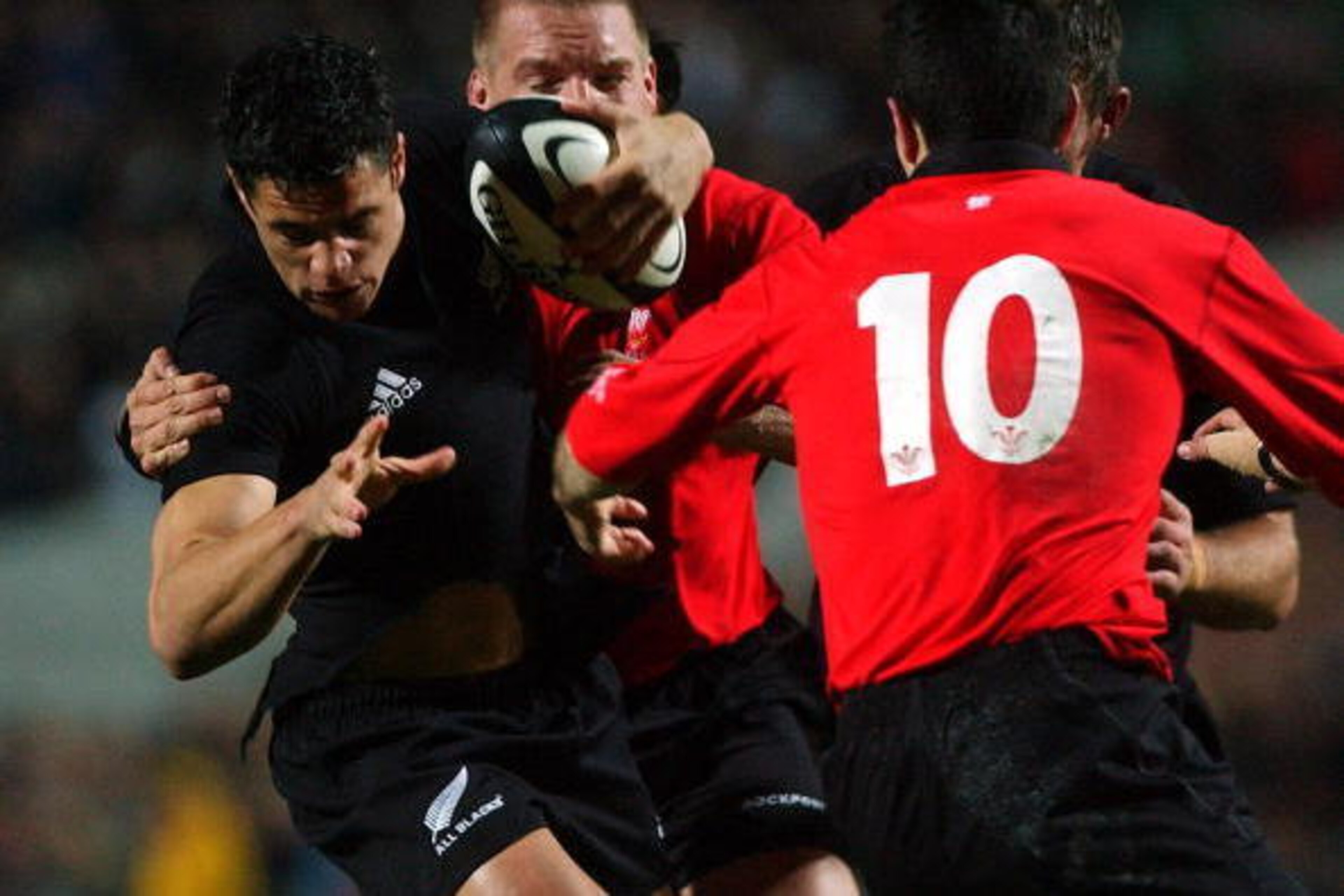 HAMILTON, NEW ZEALAND - JUNE 23:  New cap Dan Carter tries to find a way through Stephen Jones (10) during the New Zealand V Wales rugby union match in Hamilton, New Zealand, Saturday. The All Blacks won the match553.Fotopress/Ross Land..  (Photo by Ross 