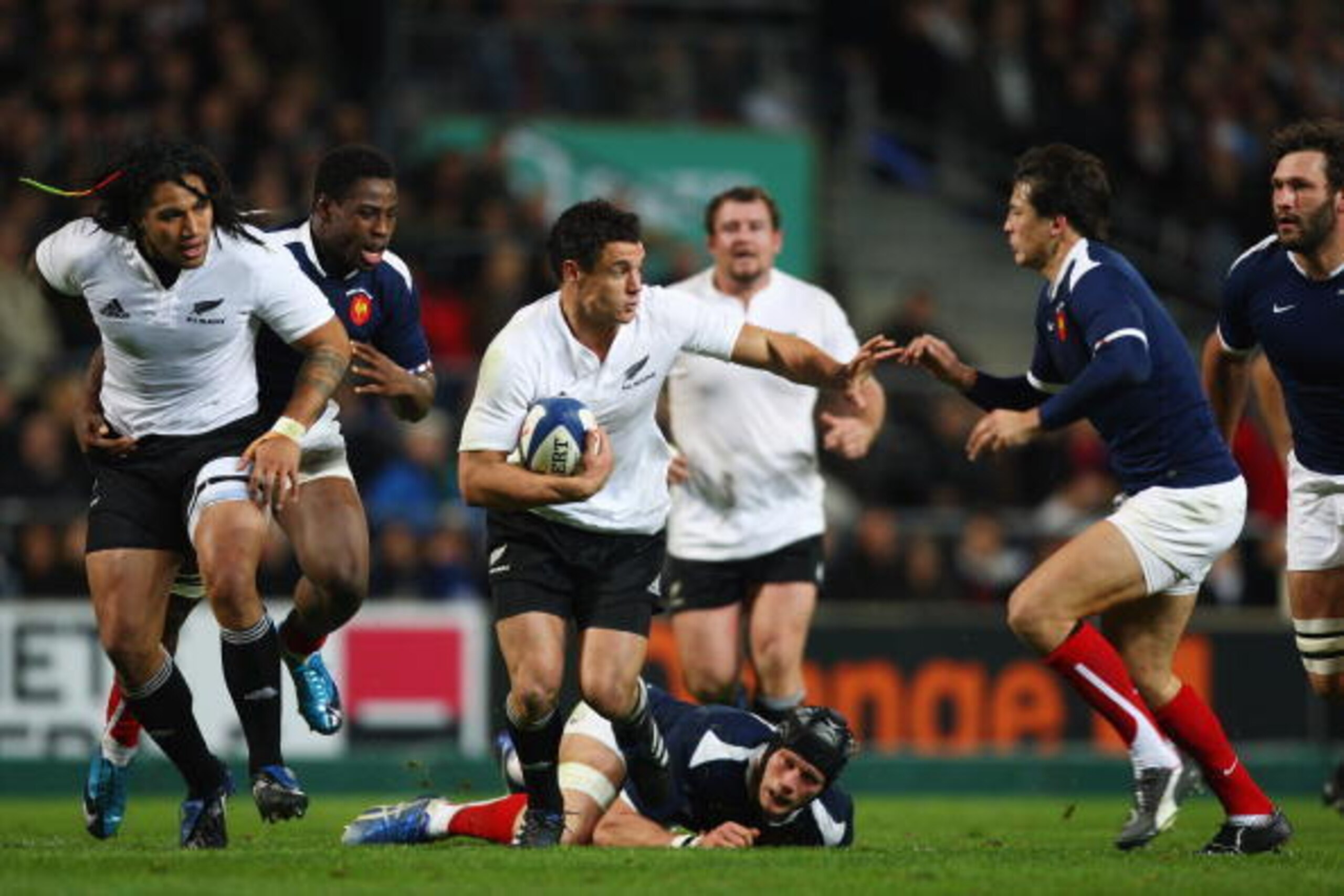 MARSEILLE, FRANCE - NOVEMBER 28:  Dan Carter of New Zealand holds off Francois Trinh- Duc (R) of France during the  international match between France and New Zealand at the Stade Velodrome on November 28, 2009 in Marseille, France.  (Photo by Michael Ste