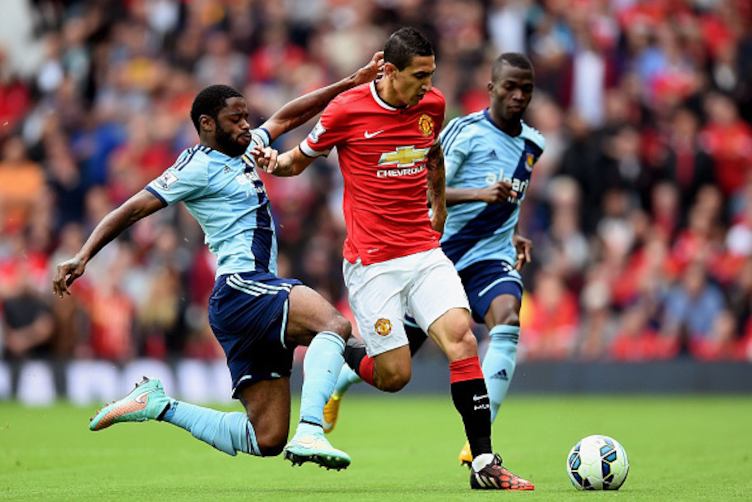 MANCHESTER, ENGLAND - SEPTEMBER 27:  Angel di Maria of Manchester United is tackled by Alexandre Song of West Ham during the Barclays Premier League match between Manchester United and West Ham United at Old Trafford on September 27, 2014 in Manchester, E