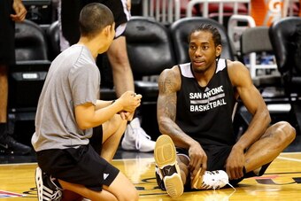 MIAMI, FL - JUNE 11: Kawhi Leonard #2 of the San Antonio Spurs stretches during practice on an off day following Game Three of the 2014 NBA Finals against the Miami Heat at American Airlines Arena on June 11, 2014 in Miami, Florida. NOTE TO USER: User exp