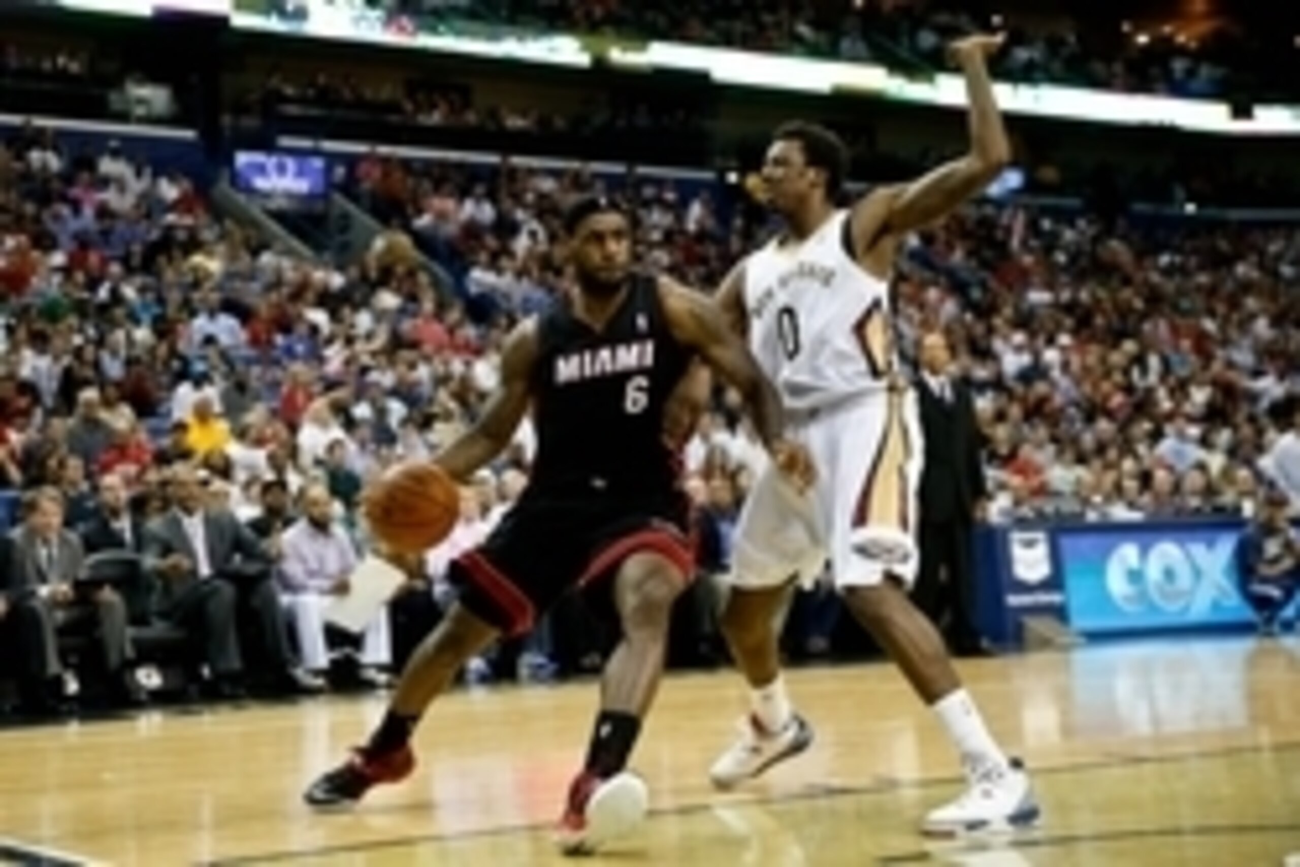 Mar 22, 2014; New Orleans, LA, USA; Miami Heat forward LeBron James (6) is defended by New Orleans Pelicans forward Al-Farouq Aminu (0) during the second half of a game at the Smoothie King Center. The Pelicans defeated the Heat 105-95. Mandatory Credit: