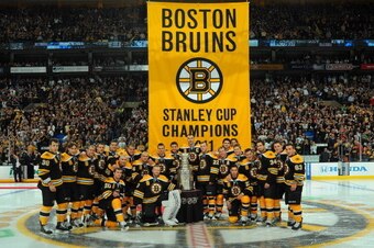 BOSTON, MA - OCTOBER 6: The Boston Bruins pose with the Stanley Cup in front of the 2011 banner before the game against the Philadelphia Flyers at the TD Garden on October 6, 2011 in Boston, Massachusetts.  (Photo by Steve Babineau/NHLI via Getty Images)