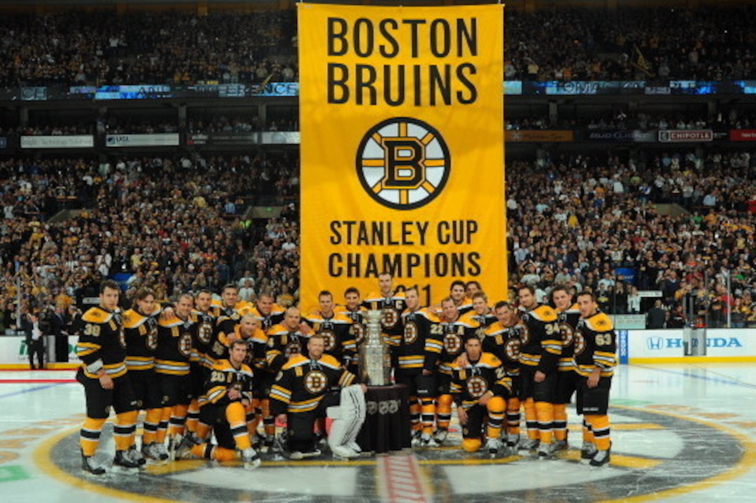 BOSTON, MA - OCTOBER 6: The Boston Bruins pose with the Stanley Cup in front of the 2011 banner before the game against the Philadelphia Flyers at the TD Garden on October 6, 2011 in Boston, Massachusetts.  (Photo by Steve Babineau/NHLI via Getty Images)