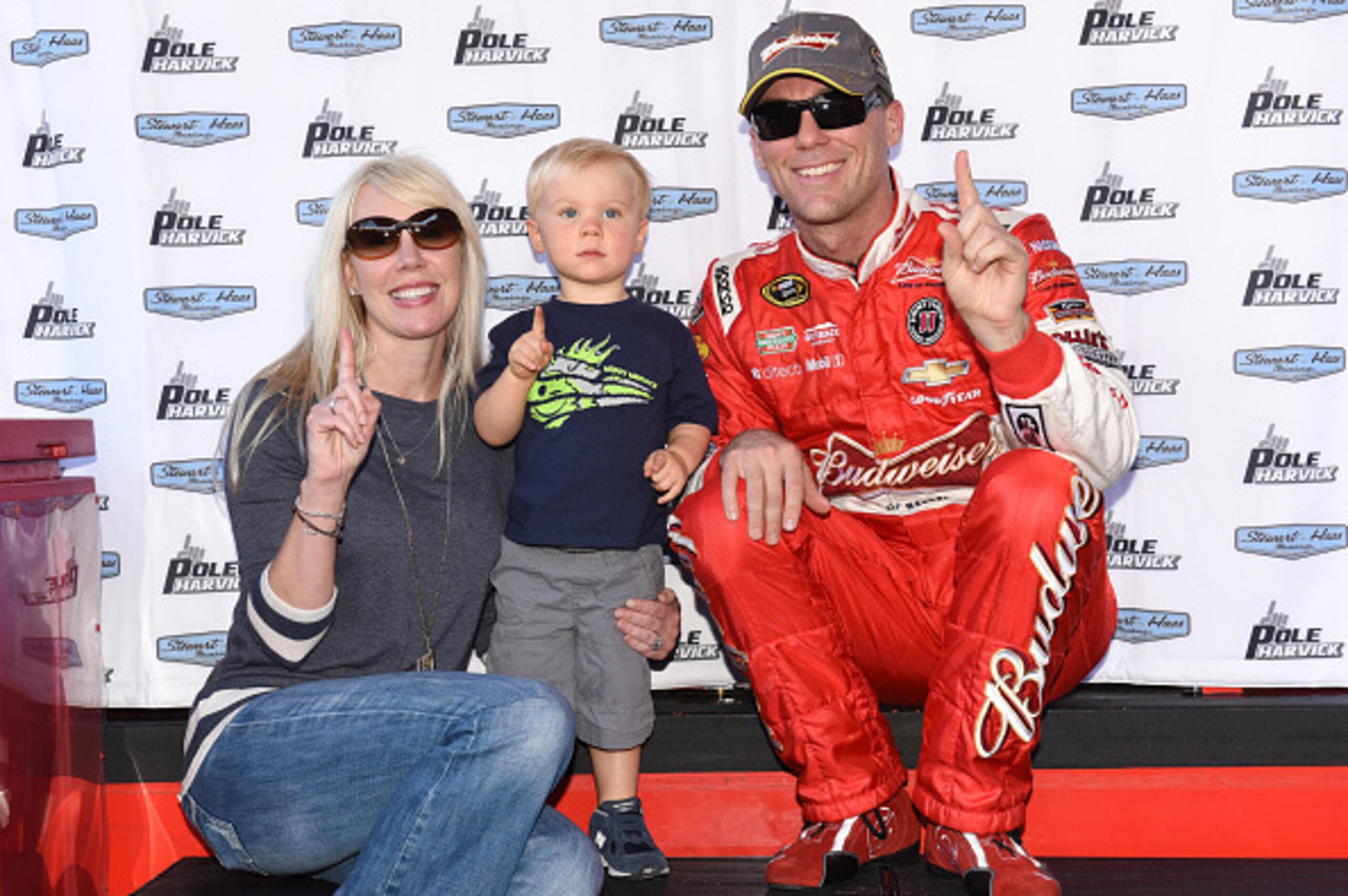 DOVER, DE - SEPTEMBER 26: Kevin Harvick, driver of the #4 Budweiser Chevrolet, poses with wife DeLana and son Keelan after qualifying on pole for the NASCAR Sprint Cup Series AAA 400 at Dover International Speedway on September 26, 2014 in Dover, Delaware