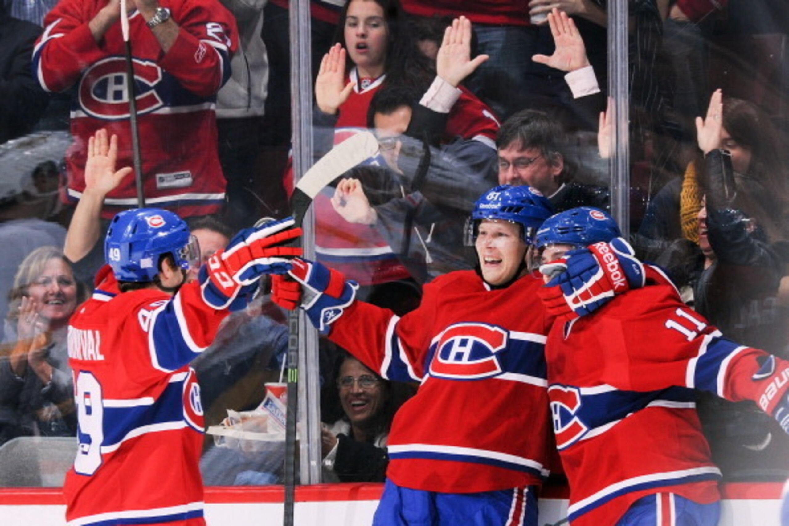 MONTREAL, QC - OCTOBER 19: Michael Bournival #49, Lars Eller #81 and Brendan Gallagher #11 of the Montreal Canadiens celebrate after scoring a goal in the second period against  the Nashville Predators during the NHL game on October 19, 2013 at the Bell C