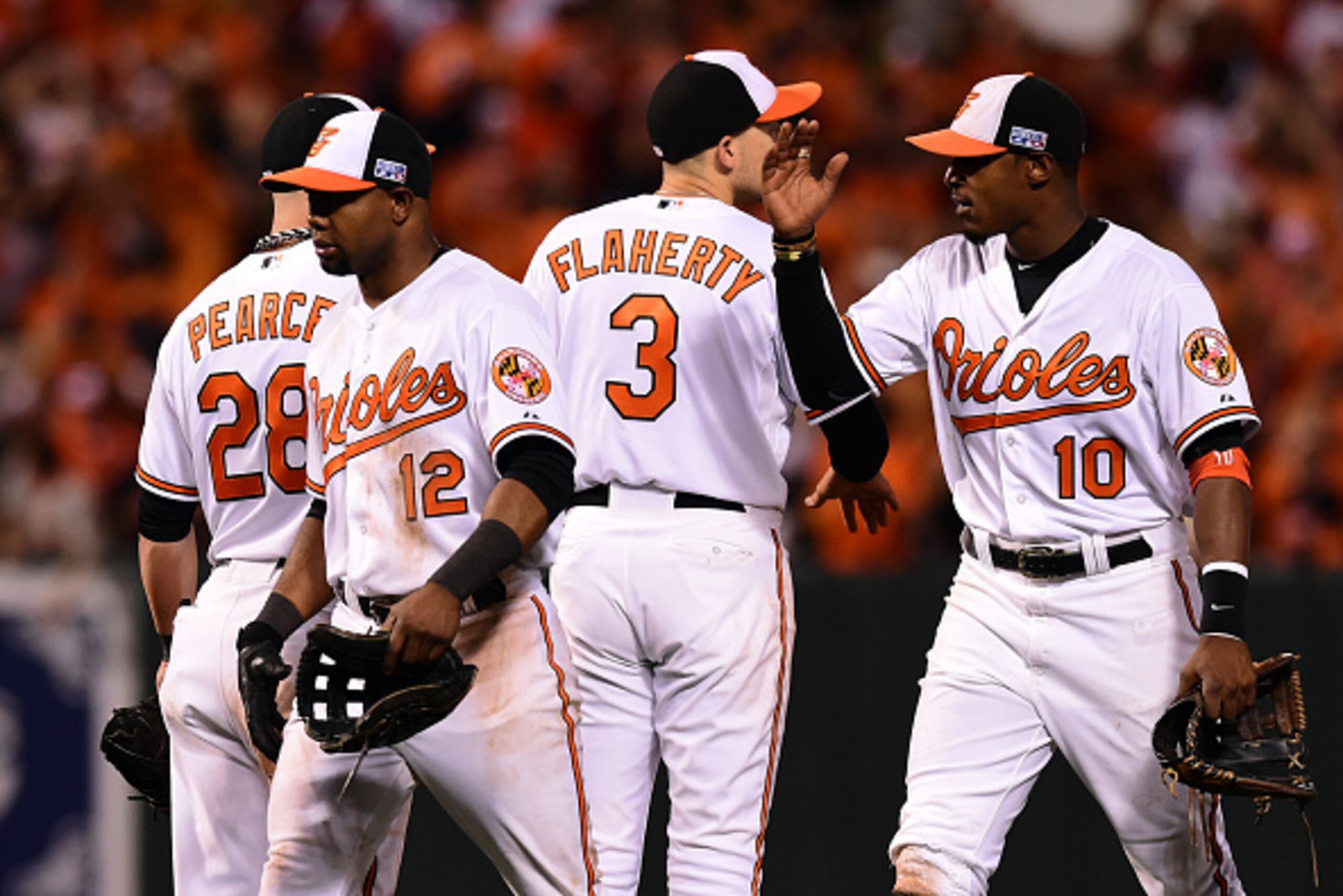 BALTIMORE, MD - OCTOBER 02:  Adam Jones #10 of the Baltimore Orioles celebrates with Ryan Flaherty #3 after defeating the Detroit Tigers 12-3 in Game One of the American League Division Series at Oriole Park at Camden Yards on October 2, 2014 in Baltimore