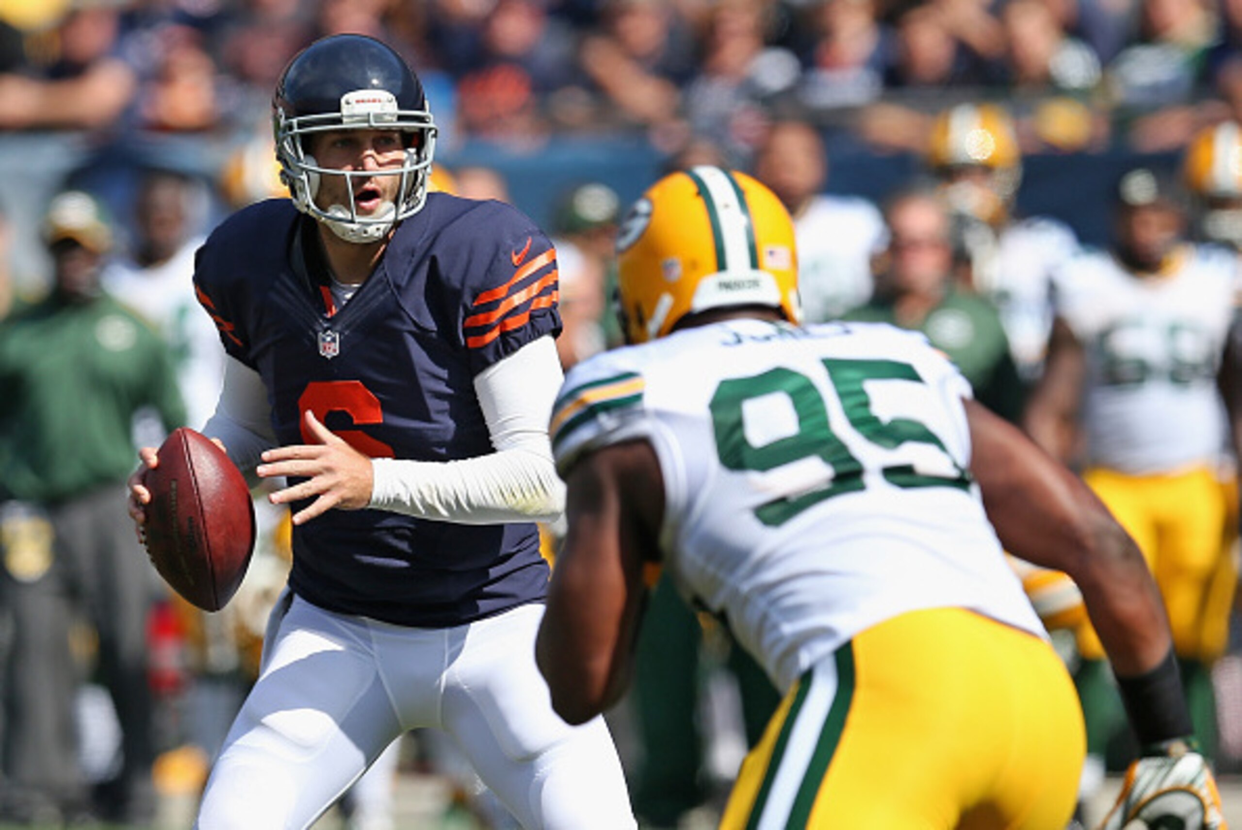 CHICAGO, IL - SEPTEMBER 28:  Jay Cutler #6 of the Chicago Bears looks to pass as  Datone Jones #95 of the Green Bay Packers pressures durng the first quarter at Soldier Field on September 28, 2014 in Chicago, Illinois. (Photo by Jonathan Daniel/Getty Imag