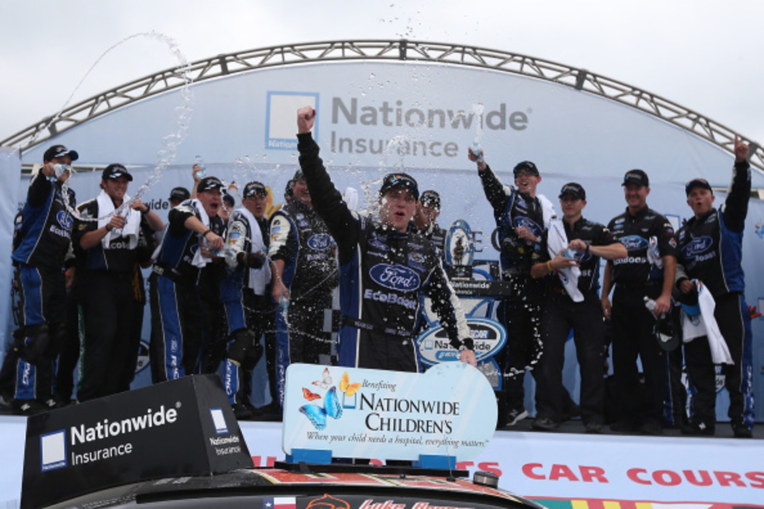 LEXINGTON, OH - AUGUST 16:  Chris Buescher, driver of the #60 Nationwide Children's Hospital Ford Mustang Ford, celebrates in victory lane after winning the Nationwide Children's Hospital 200 at Mid-Ohio Sports Car Course on August 16, 2014 in Lexington, 