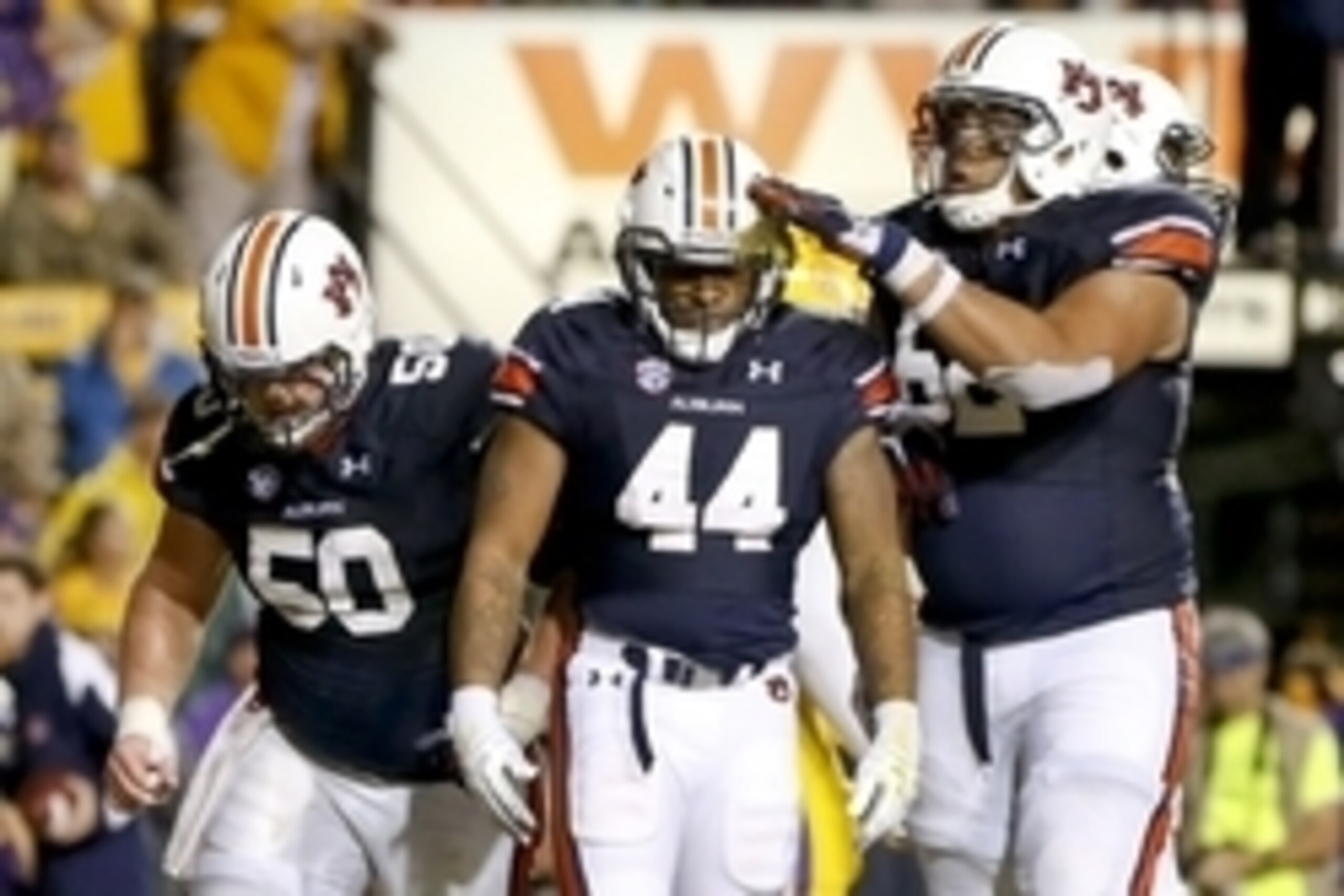 Sep 21, 2013; Baton Rouge, LA, USA; Auburn Tigers running back Cameron Artis-Payne (44) with teammates center Reese Dismukes (50) and offensive linesman Chad Slade (62) during the second half of a game at Tiger Stadium. LSU defeated Auburn 35-21. Mandator