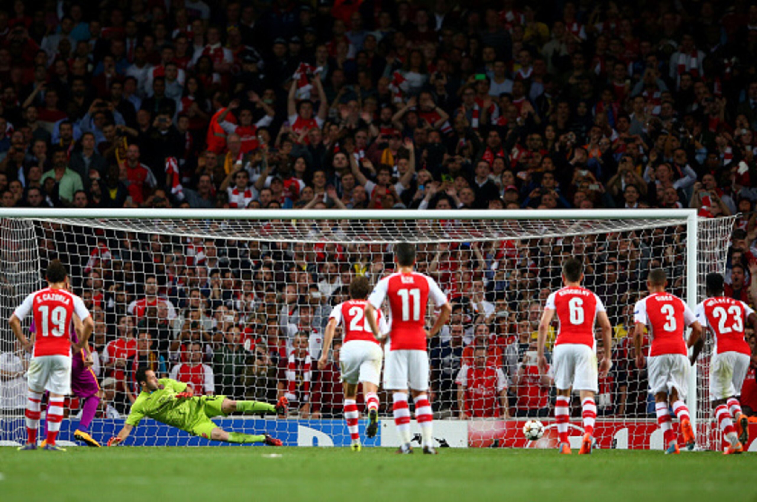 LONDON, ENGLAND - OCTOBER 01:  David Ospina of Arsenal fails to stop Burak Yilmaz of Galatasaray AS' penalty during the UEFA Champions League group D match between Arsenal FC and Galatasaray AS at Emirates Stadium on October 1, 2014 in London, United King