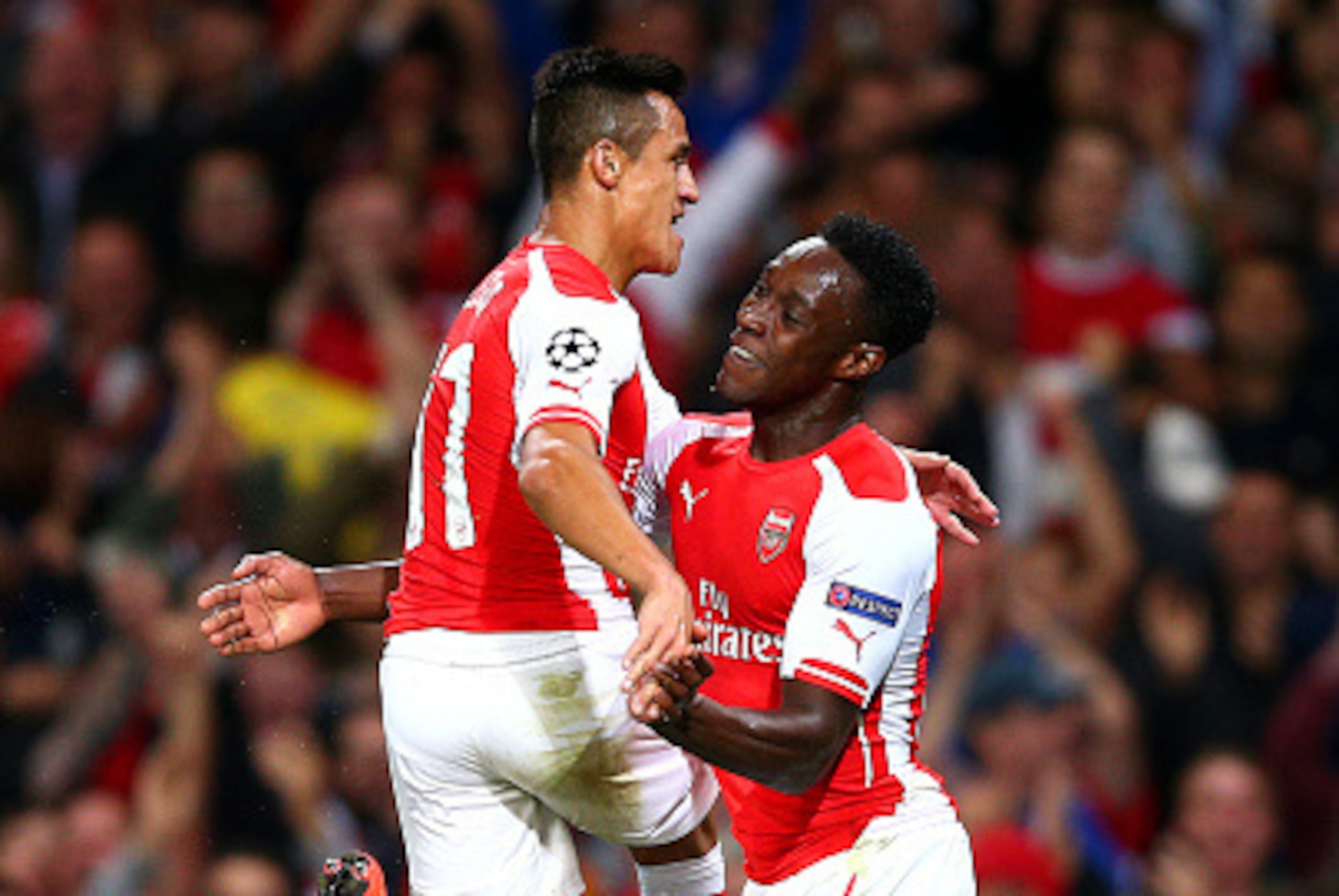 LONDON, ENGLAND - OCTOBER 01:  Danny Welbeck of Arsenal celebrates with team-mate Alexis Sanchez after scoring his team's second goal during the UEFA Champions League group D match between Arsenal FC and Galatasaray AS at Emirates Stadium on October 1, 20