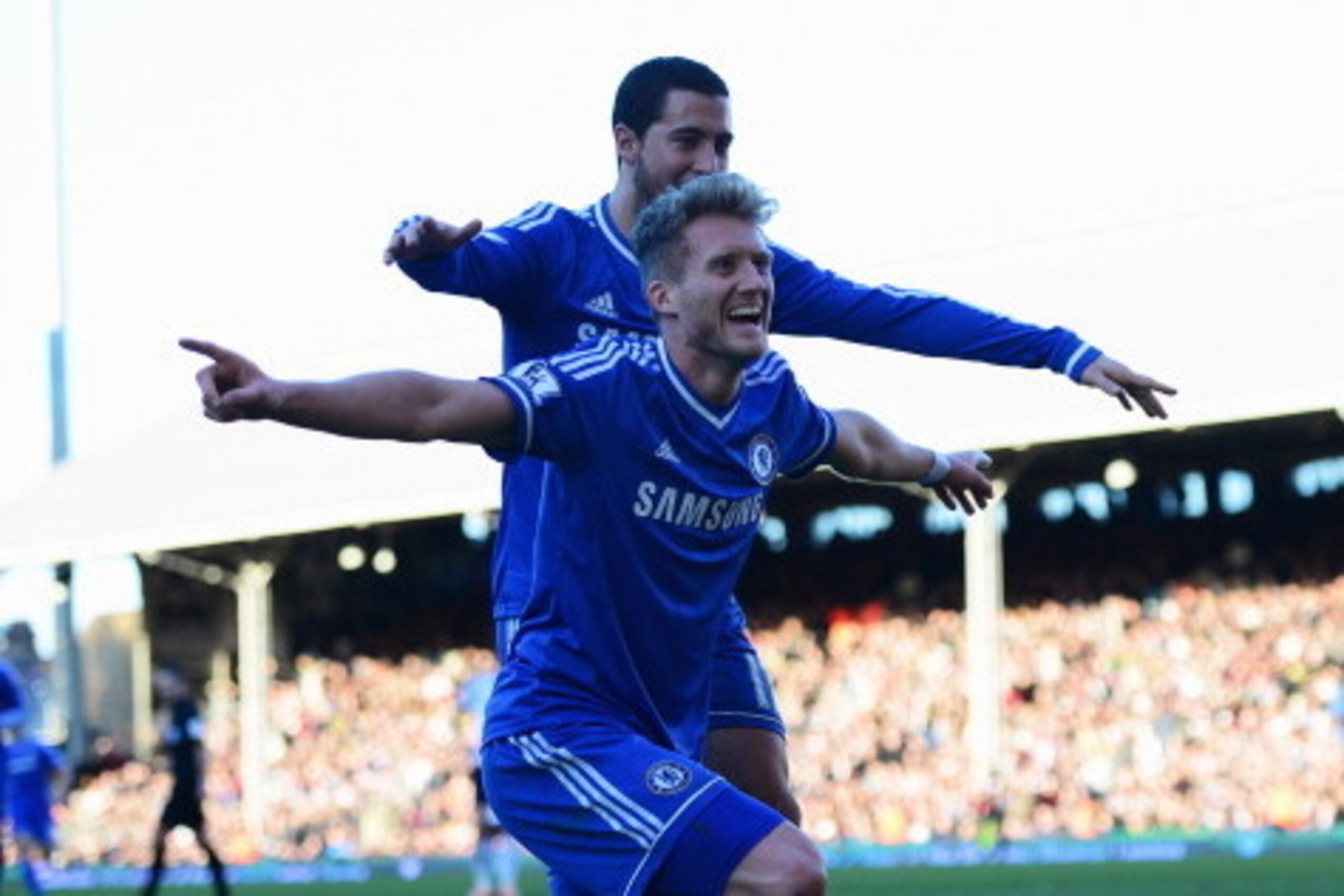 LONDON, ENGLAND - MARCH 01:  Andre Schurrle of Chelsea celebrates with Eden Hazard as he scores their third goal and completes his hat trick during the Barclays Premier League match between Fulham and Chelsea at Craven Cottage on March 1, 2014 in London, 
