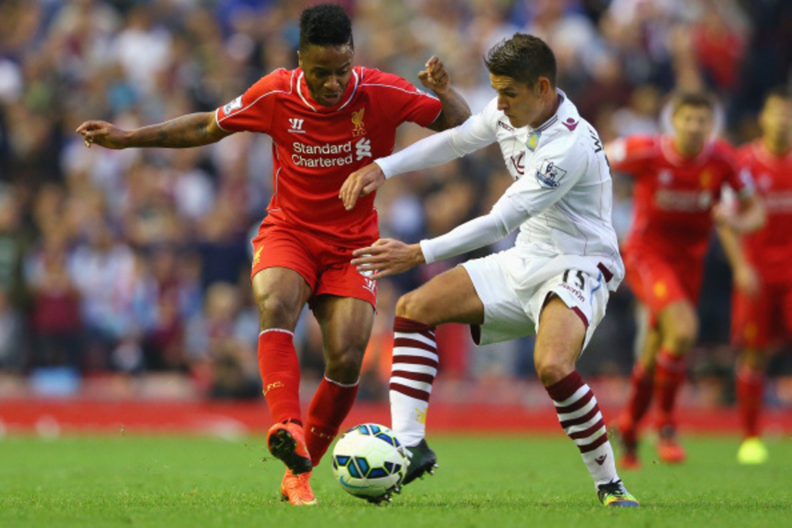 LIVERPOOL, ENGLAND - SEPTEMBER 13: Raheem Sterling of Liverpool is tackled by Ashley Westwood of Aston Villa during the Barclays Premier League match between Liverpool and Aston Villa at Anfield on September 13, 2014 in Liverpool, England.  (Photo by Alex