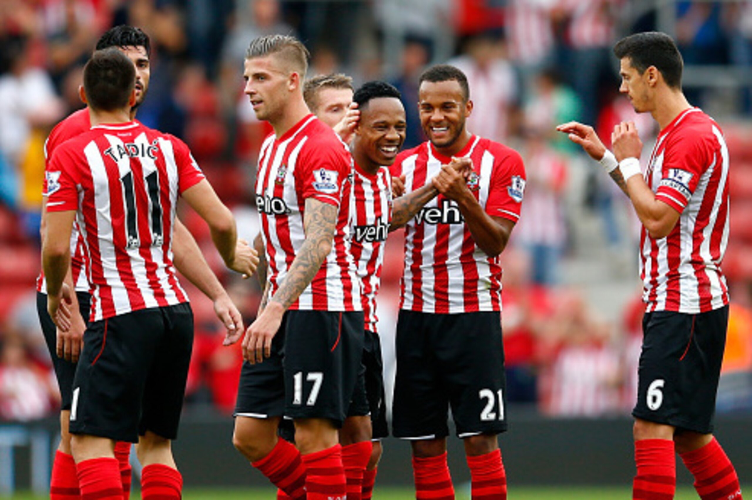 SOUTHAMPTON, ENGLAND - SEPTEMBER 27: Ryan Bertrand (2nd R) of Southampton celebrates their victory with Nathaniel Clyne (C) and their team-mates during the Barclays Premier League match between Southampton and Queens Park Rangers at St Mary's Stadium on SOUTHAMPTON, ENGLAND - SEPTEMBER 27: Ryan Bertrand (2nd R) of Southampton celebrates their victory with Nathaniel Clyne (C) and their team-mates during the Barclays Premier League match between Southampton and Queens Park Rangers at St Mary's Stadium on