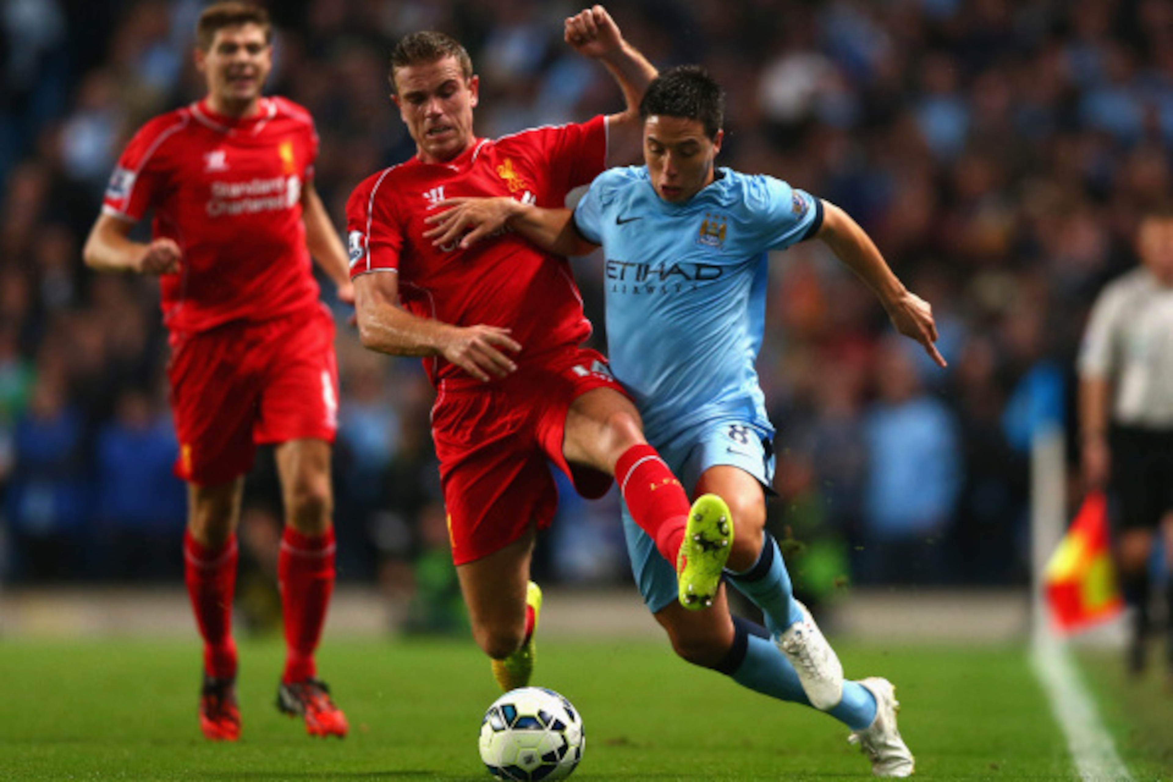MANCHESTER, ENGLAND - AUGUST 25:  Jordan Henderson of Liverpool battles with Samir Nasri of Manchester City during the Barclays Premier League match between Manchester City and Liverpool at the Etihad Stadium on August 25, 2014 in Manchester, England.  (P