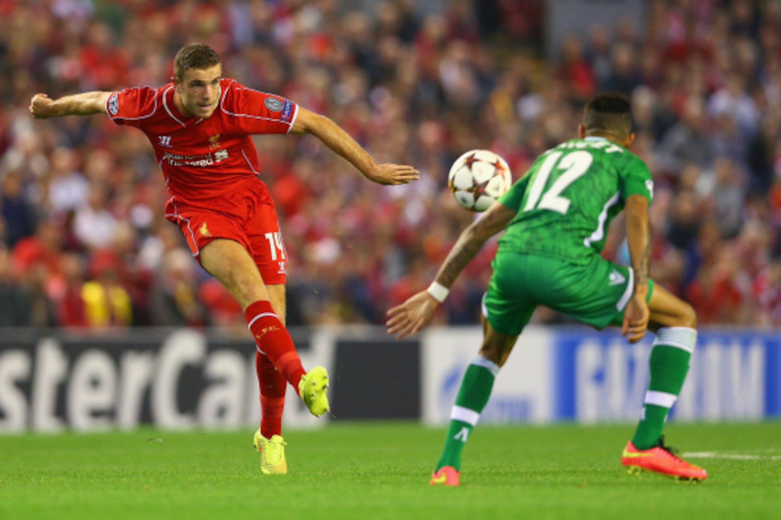 LIVERPOOL, ENGLAND - SEPTEMBER 16:  Jordan Henderson of Liverpool shoots past Anicet Abel of PFC Ludogorets Razgrad during the UEFA Champions League Group B match between Liverpool FC and PFC Ludogorets Razgrad at Anfield on September 16, 2014 in Liverpoo