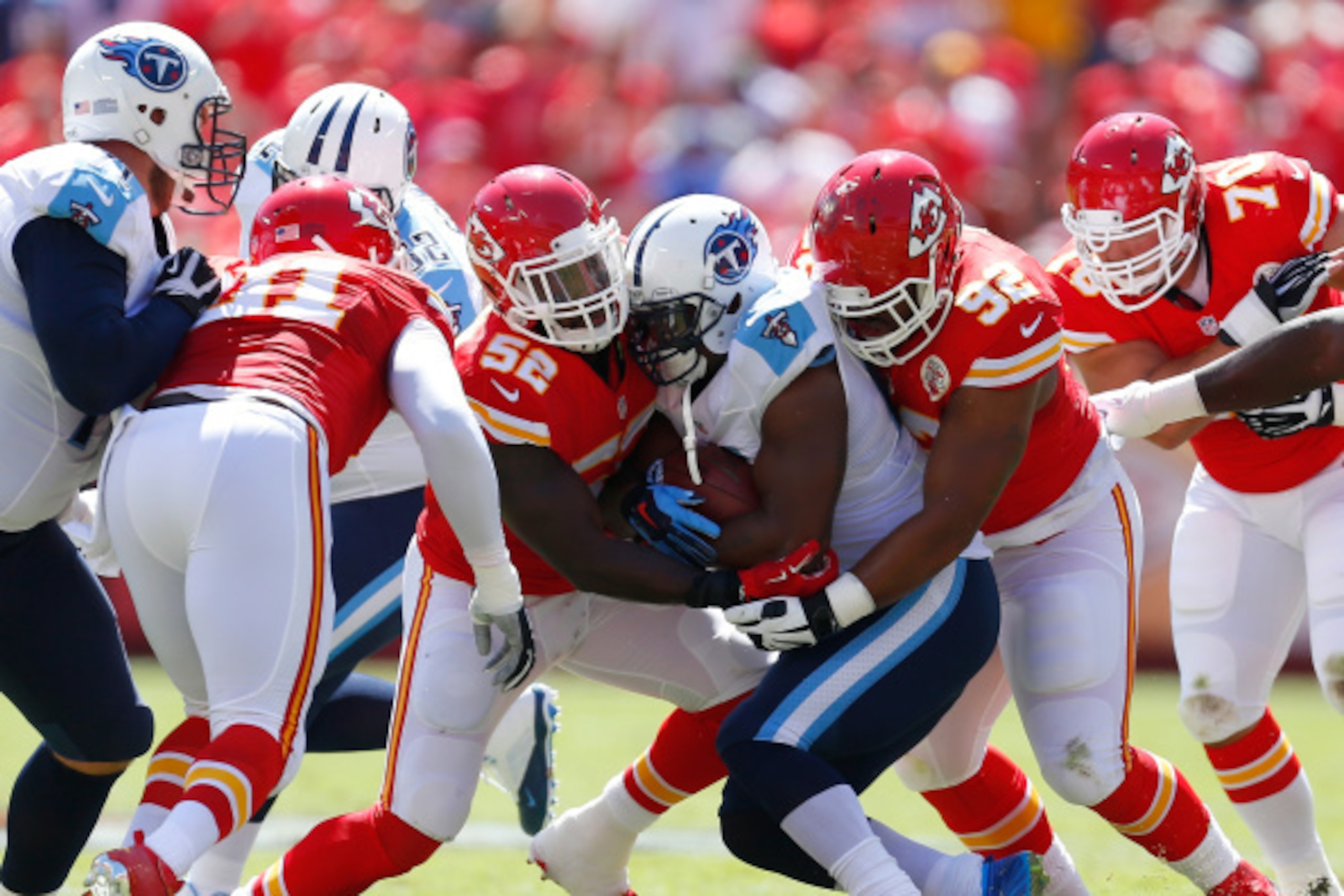 KANSAS CITY, MO - SEPTEMBER 07:  Shonn Greene #23 of the Tennessee Titans runs the ball against  James-Michael Johnson #52 and Dontari Poe #92 of the Kansas City Chiefs during the first quarter at Arrowhead Stadium on September 7, 2014 in Kansas City, Mis