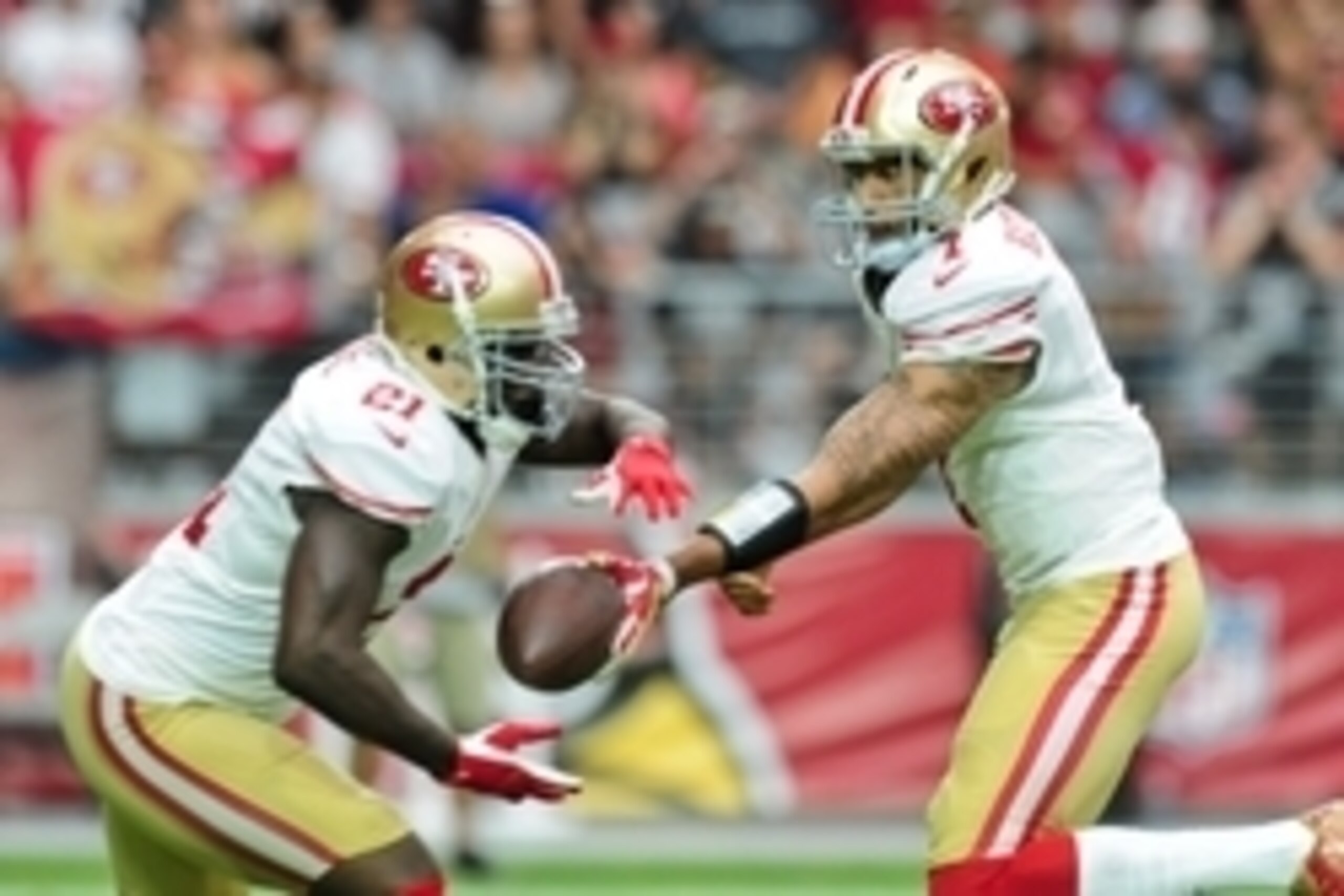 Sep 21, 2014; Glendale, AZ, USA; San Francisco 49ers quarterback Colin Kaepernick (7) hands off to running back Frank Gore (21) during the first half against the Arizona Cardinals at University of Phoenix Stadium. Mandatory Credit: Matt Kartozian-USA TODA