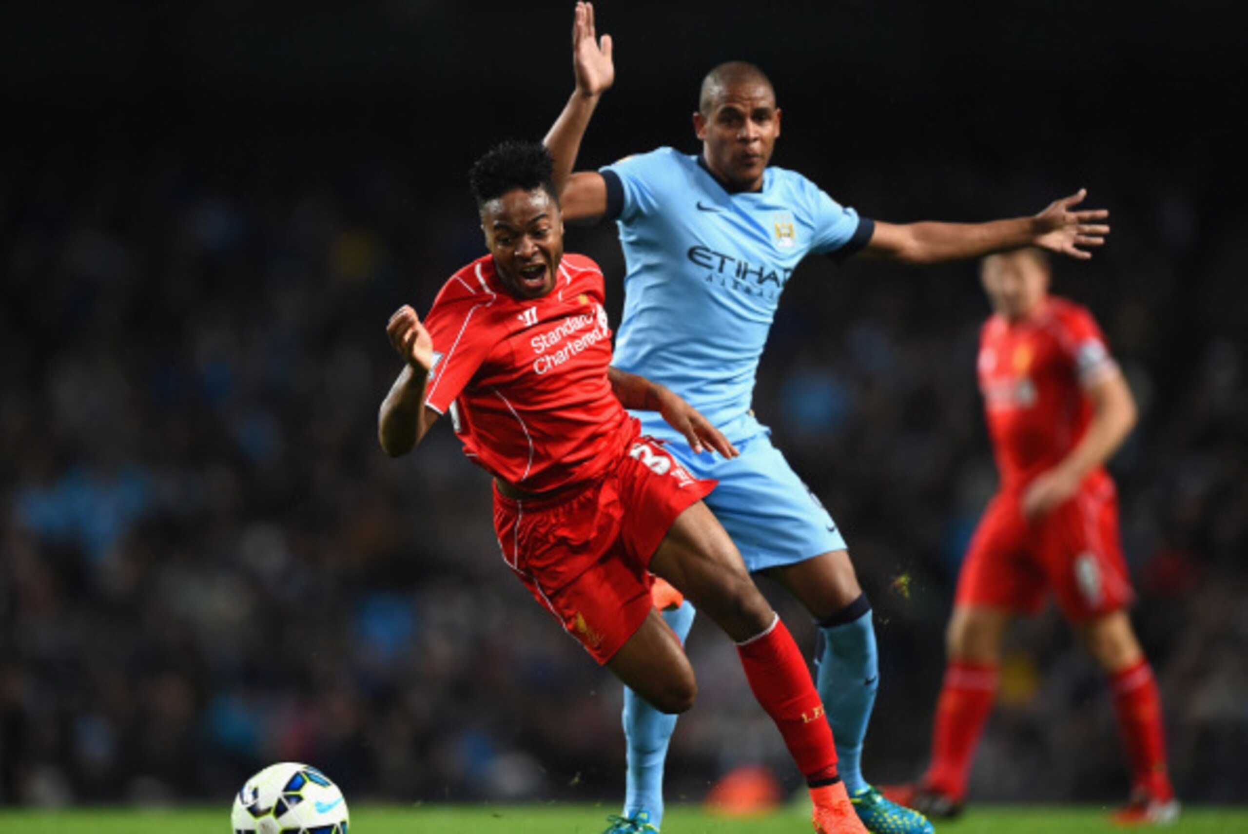 MANCHESTER, ENGLAND - AUGUST 25:  Raheem Sterling of Liverpool is challenged by Fernando Reges of Manchester City during the Barclays Premier League match between Manchester City and Liverpool at the Etihad Stadium on August 25, 2014 in Manchester, Englan