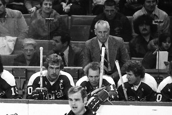 BOSTON, MA. - 1970's: Milt Schmidt coach of the Washington Capitals watches play from behind bench. Schmidt is a Bruin legend and Hall of Fame member .  (Photo by Steve Babineau/NHLI via Getty Images)