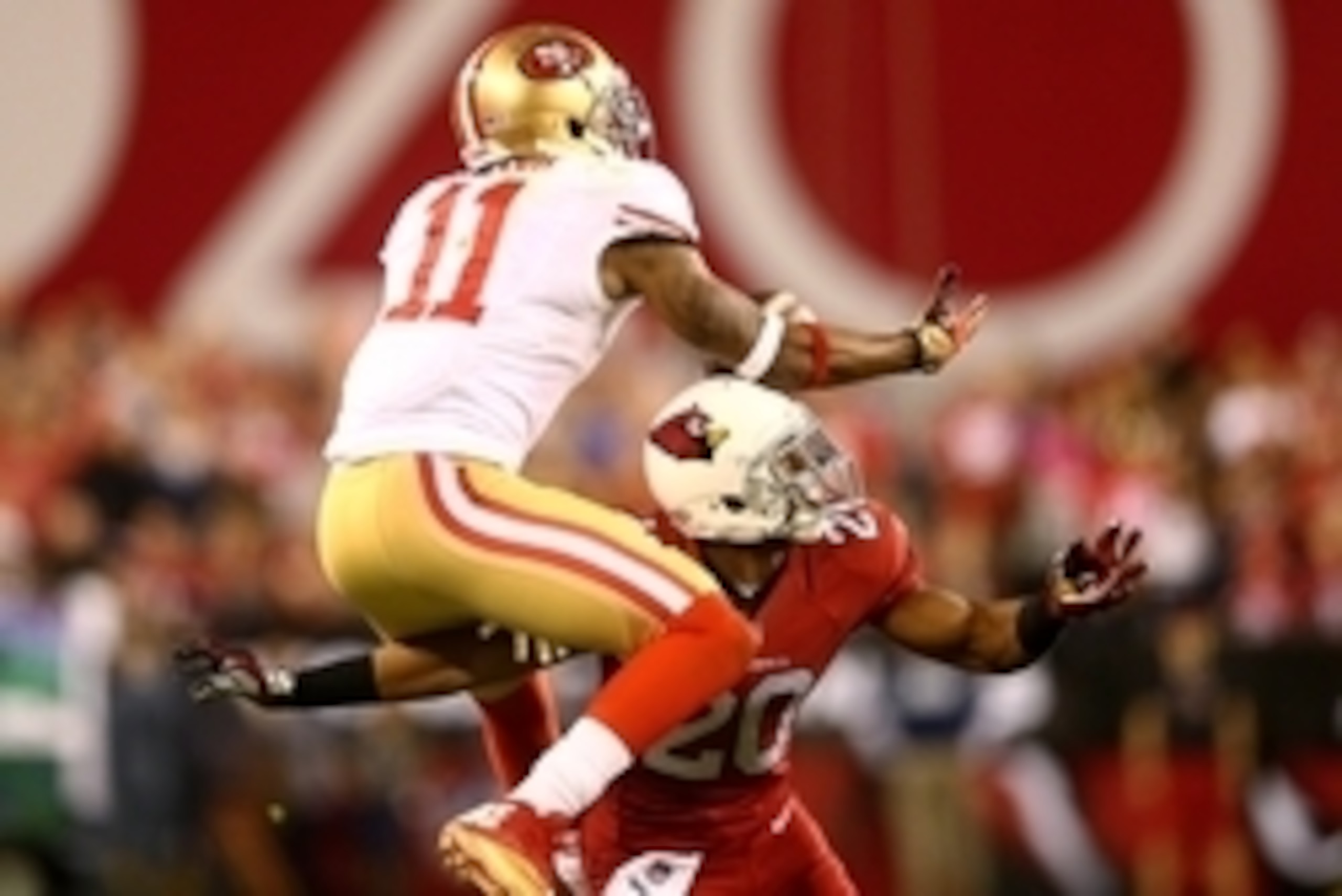 Dec 29, 2013; Phoenix, AZ, USA; San Francisco 49ers wide receiver Quinton Patton (11) catches a pass under pressure from Arizona Cardinals cornerback Antoine Cason (20) in the closing seconds of the game at University of Phoenix Stadium. The 49ers defeate