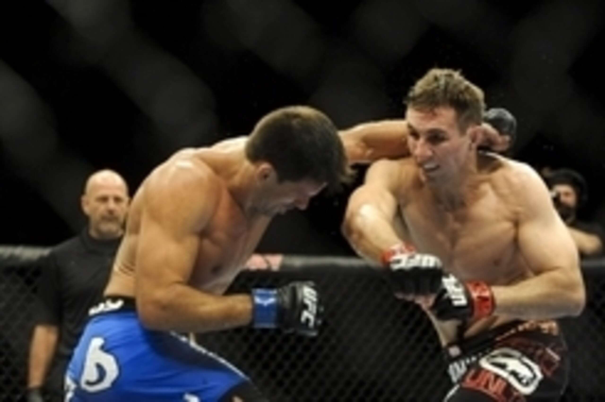 Feb 22, 2014; Las Vegas, NV, USA;  Rory MacDonald (red gloves) throws a punch at Demian Maia (blue gloves) during their UFC welterweight bout at Mandalay Bay. MacDonald won by way of a 29-28 decision. Mandatory Credit: Stephen R. Sylvanie-USA TODAY Sports