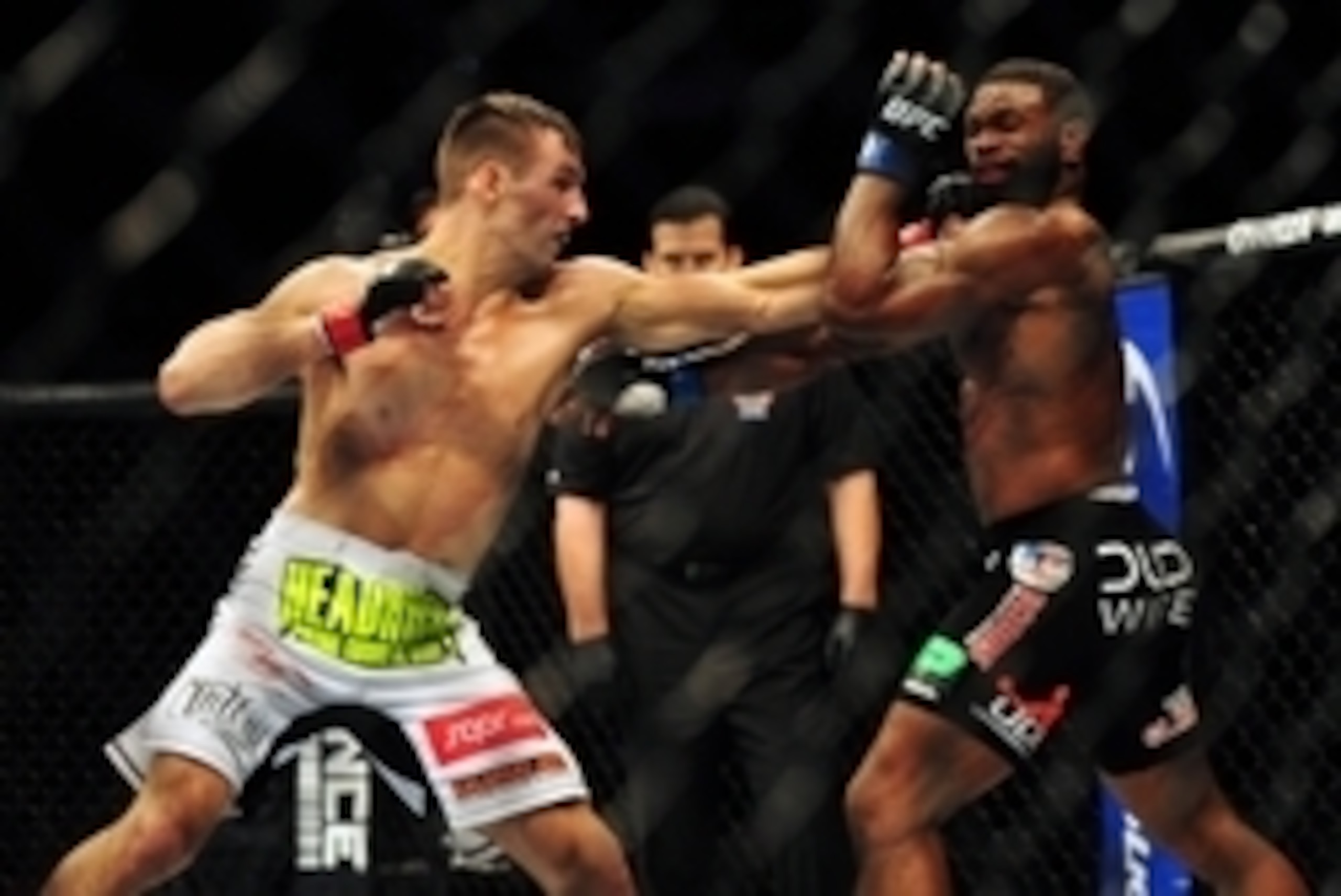 Jun 14, 2014; Vancouver, British Columbia, Canada; Rory MacDonald (red) fights against Tyron Woodley (blue) in their welterweight bout at UFC 174 at Rogers Arena. Mandatory Credit: Anne-Marie Sorvin-USA TODAY Sports